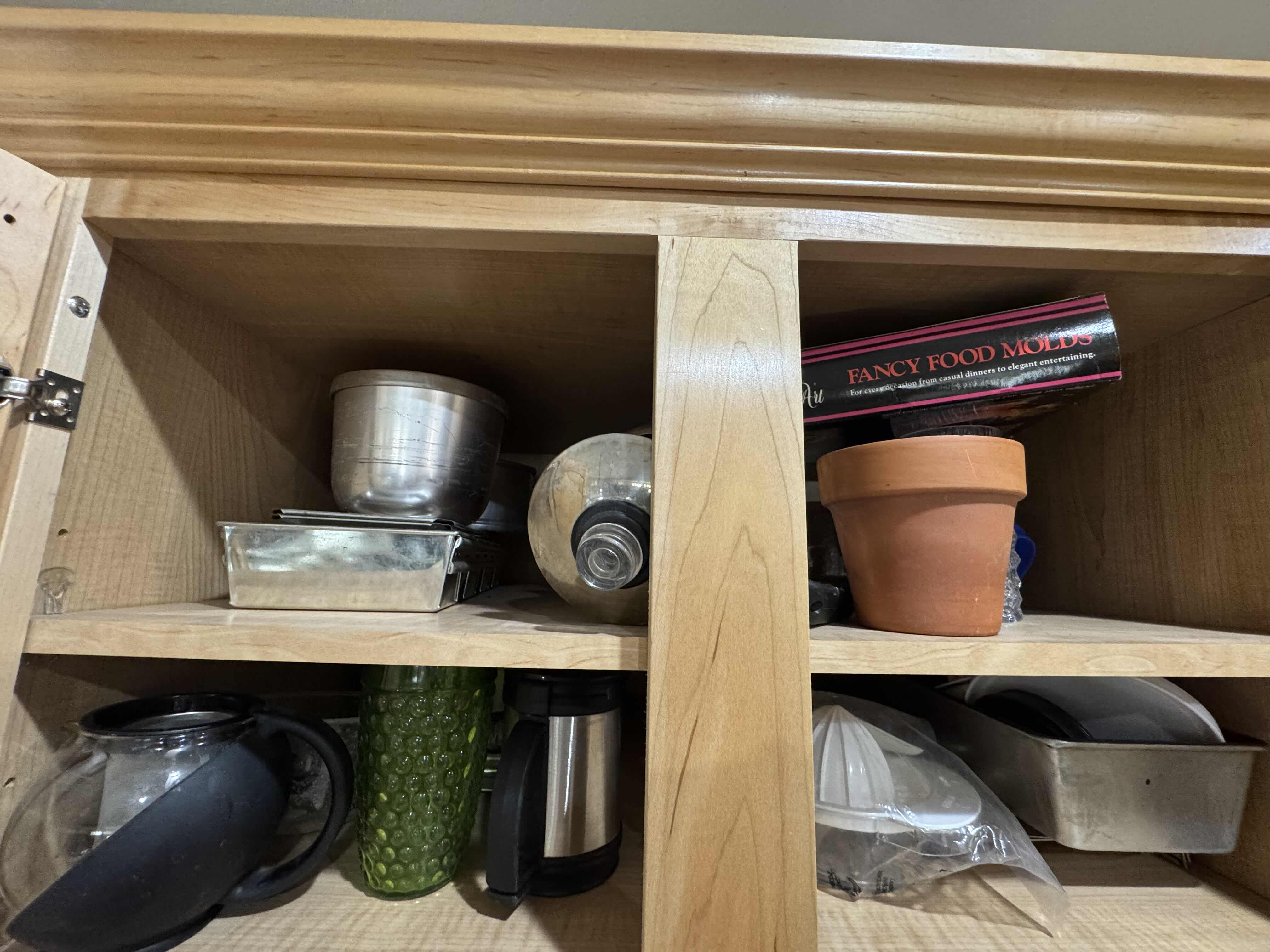 Photo 1 of CONTENTS OF CABINET- BAKING PANS AND MOLDS, GLASSWARE, PITCHER AND PLATES