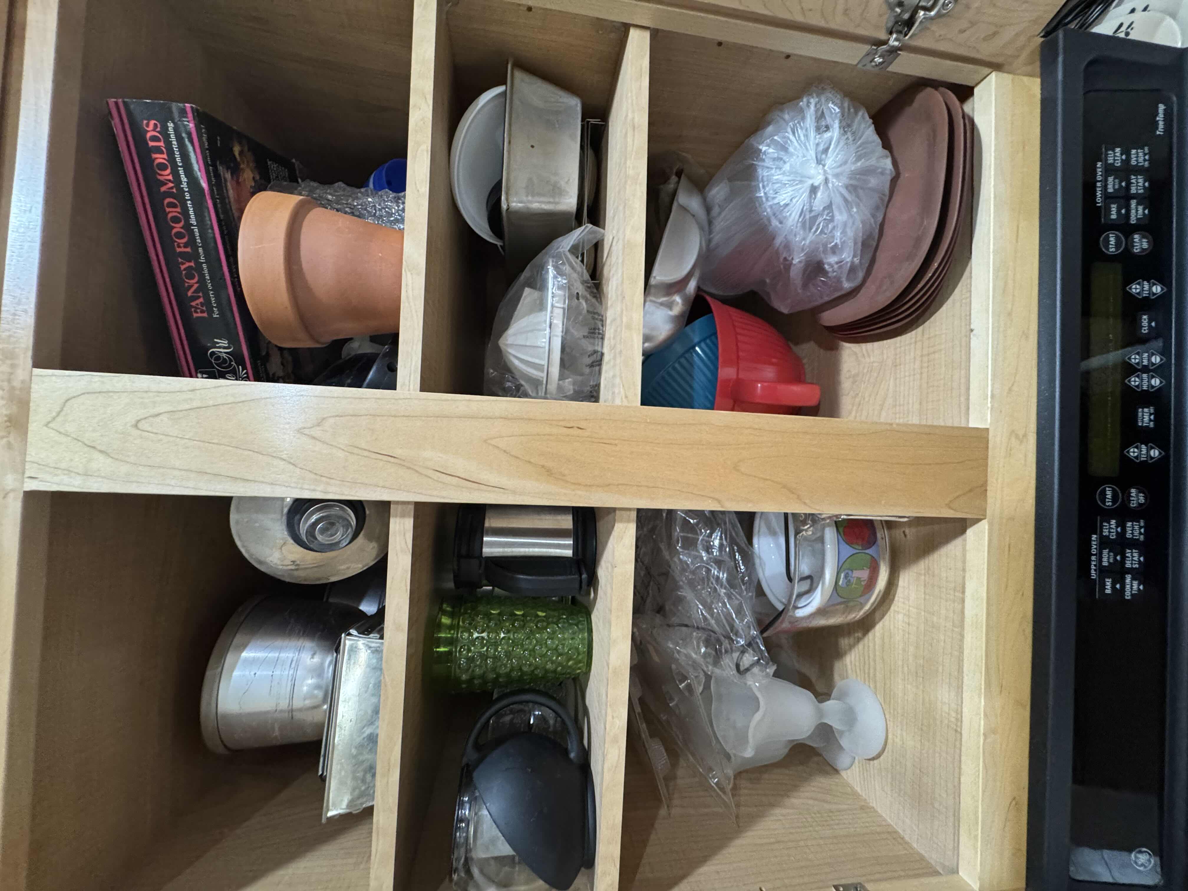 Photo 1 of CONTENTS OF CABINET- BAKING PANS AND MOLDS, GLASSWARE, PITCHER AND PLATES