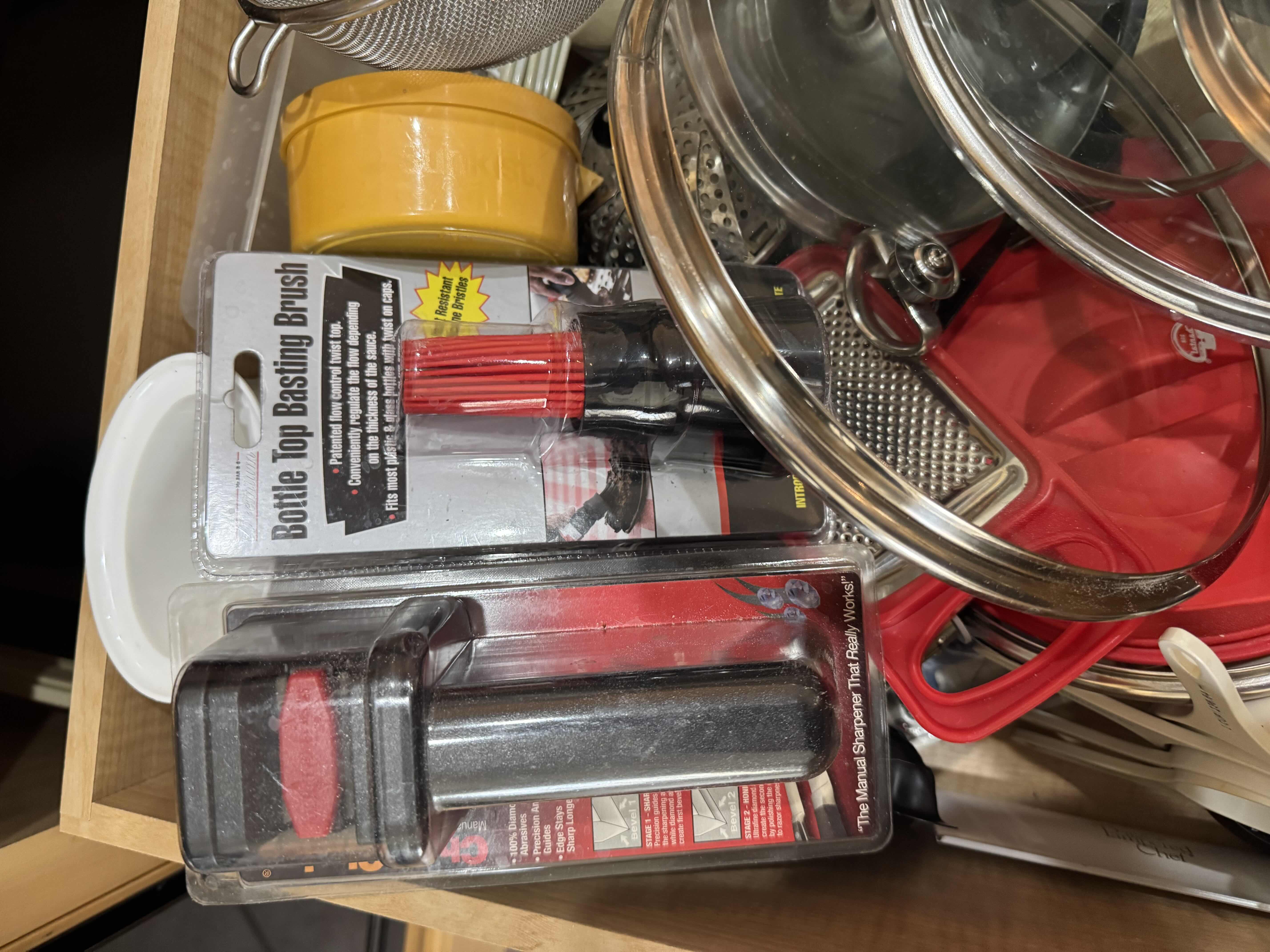 Photo 1 of CONTENTS OF DRAWER- MEASURING CUPS & SPOONS, LIDS, BASTING BRUSH, JUICER