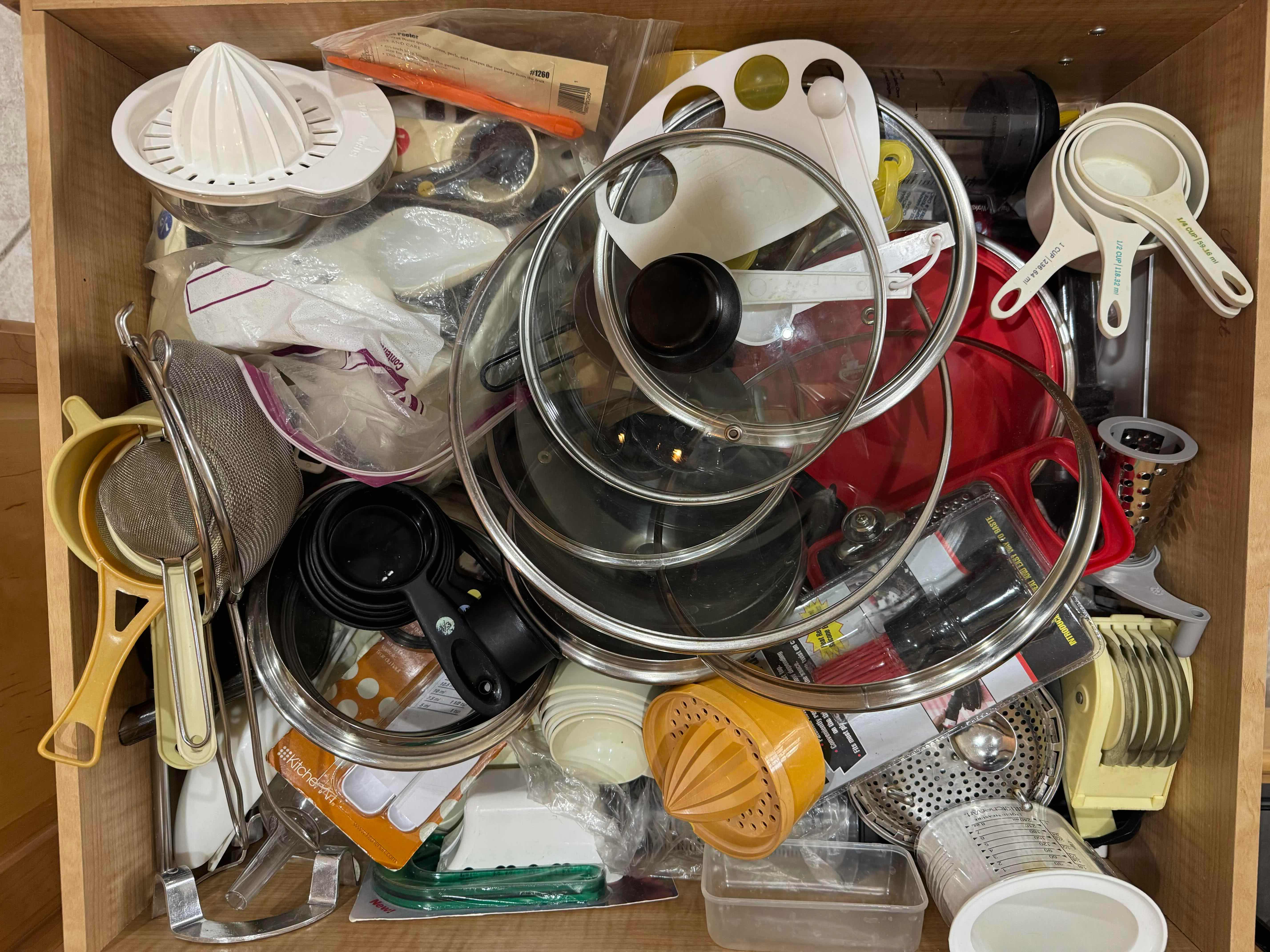 Photo 1 of CONTENTS OF DRAWER- MEASURING CUPS & SPOONS, LIDS, BASTING BRUSH, JUICER