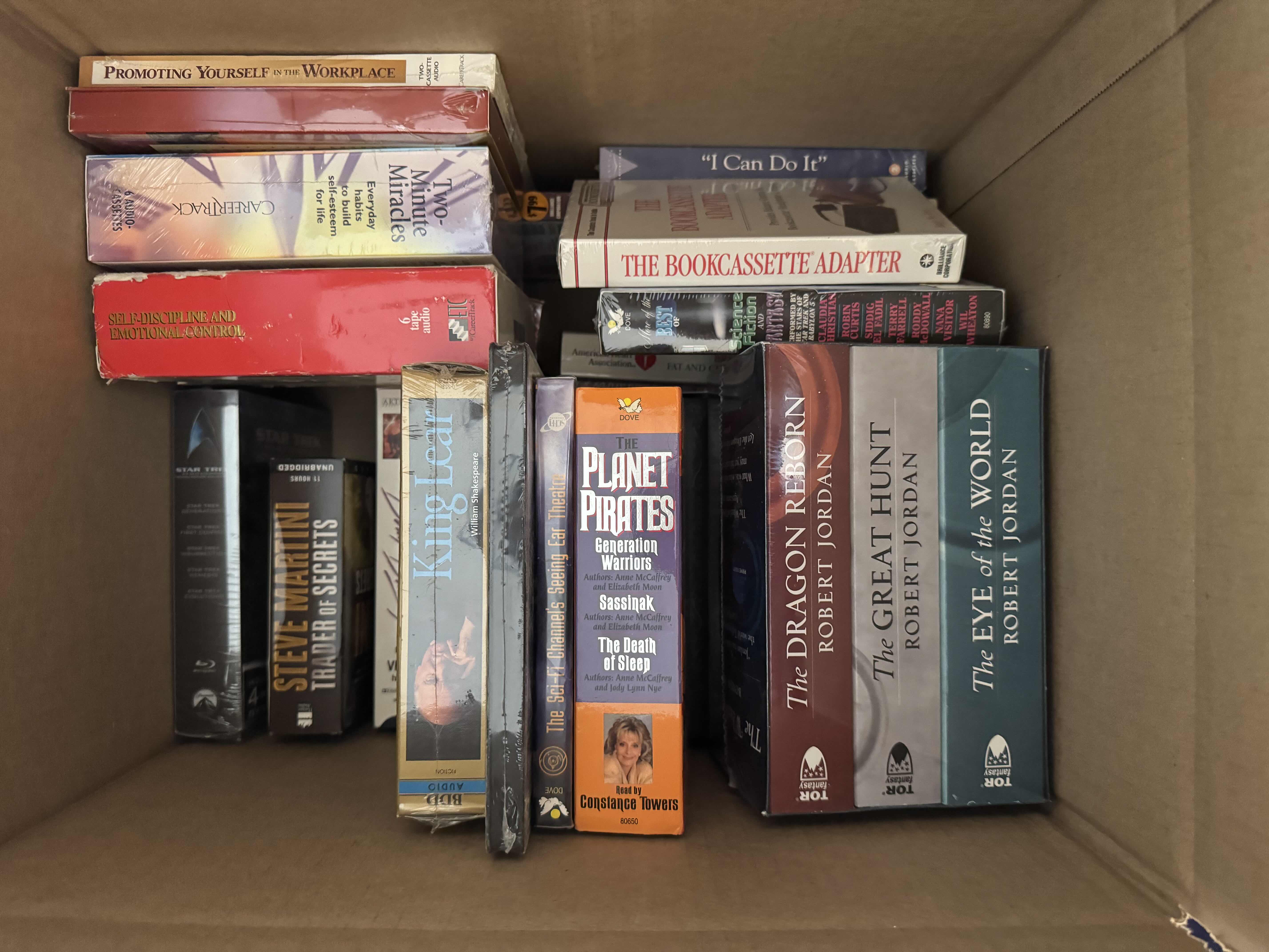 Photo 1 of BOX OF ASSORTED MEDIA, AUDIO BOOKS, BOOKS, BLU-RAY, VHS, AND CASSETTES