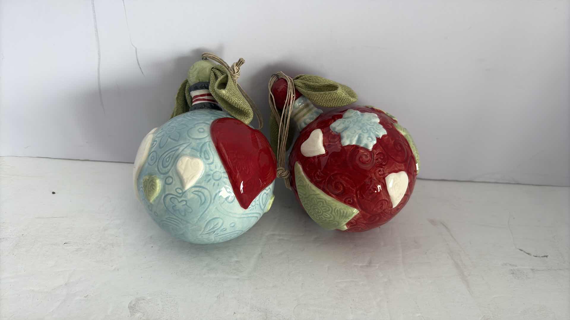 Photo 1 of TWO HANDCRAFTED ROUND CERAMIC ORNAMENTS 6”