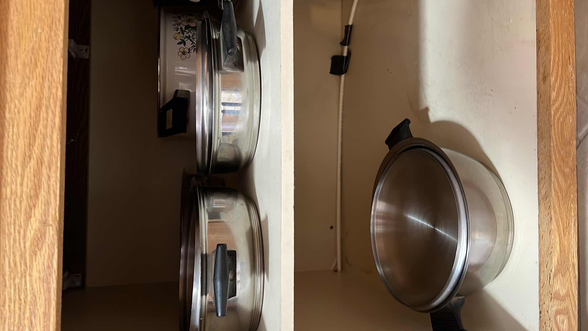 Photo 1 of CONTENTS OF KITCHEN CABINET. POTS AND PANS.