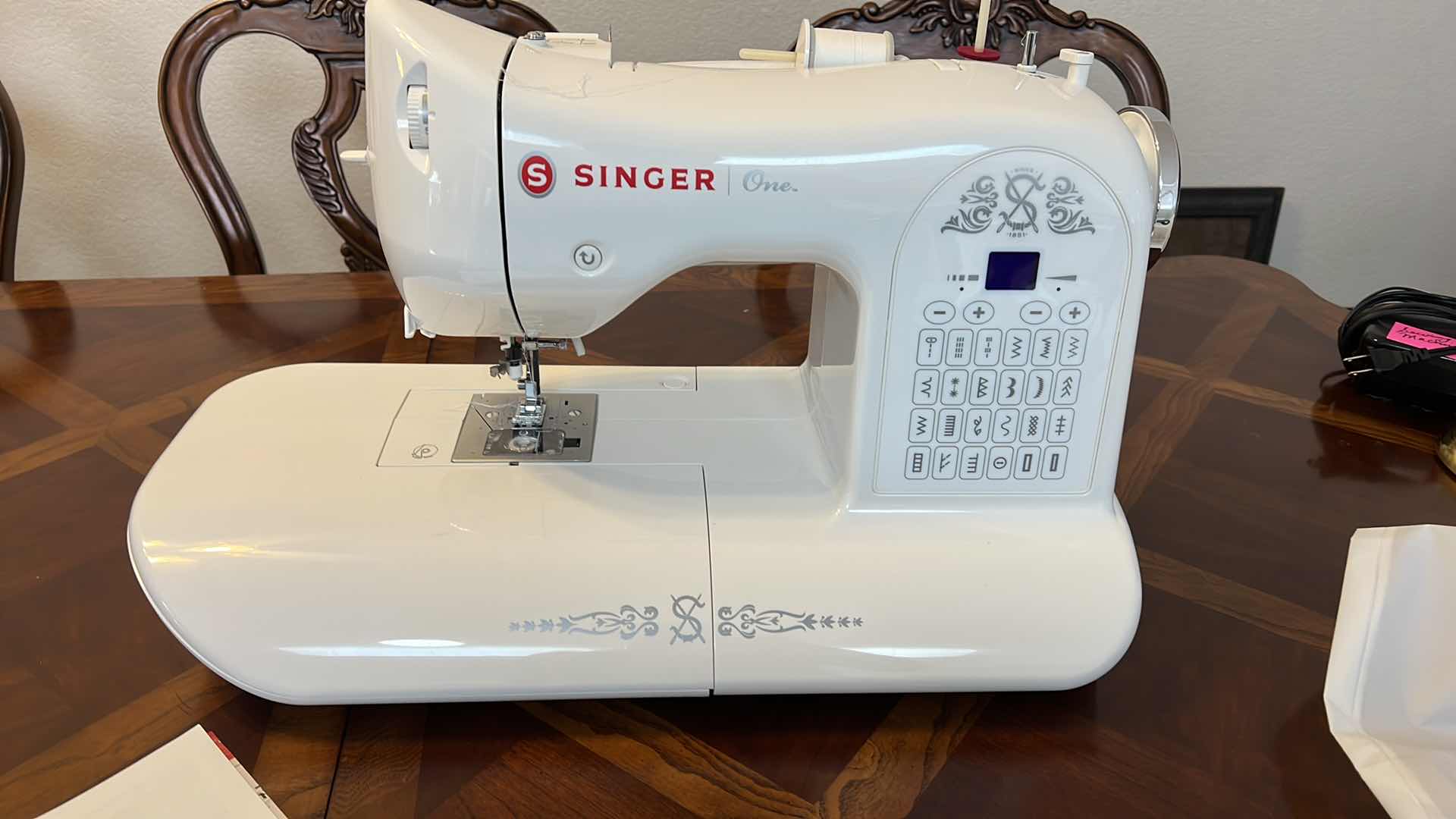 Photo 1 of SINGER SEWING MACHING WITH INSTRUCTION BOOK.