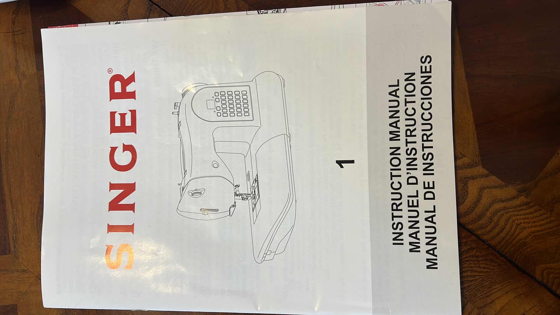Photo 1 of SINGER SEWING MACHING WITH INSTRUCTION BOOK.