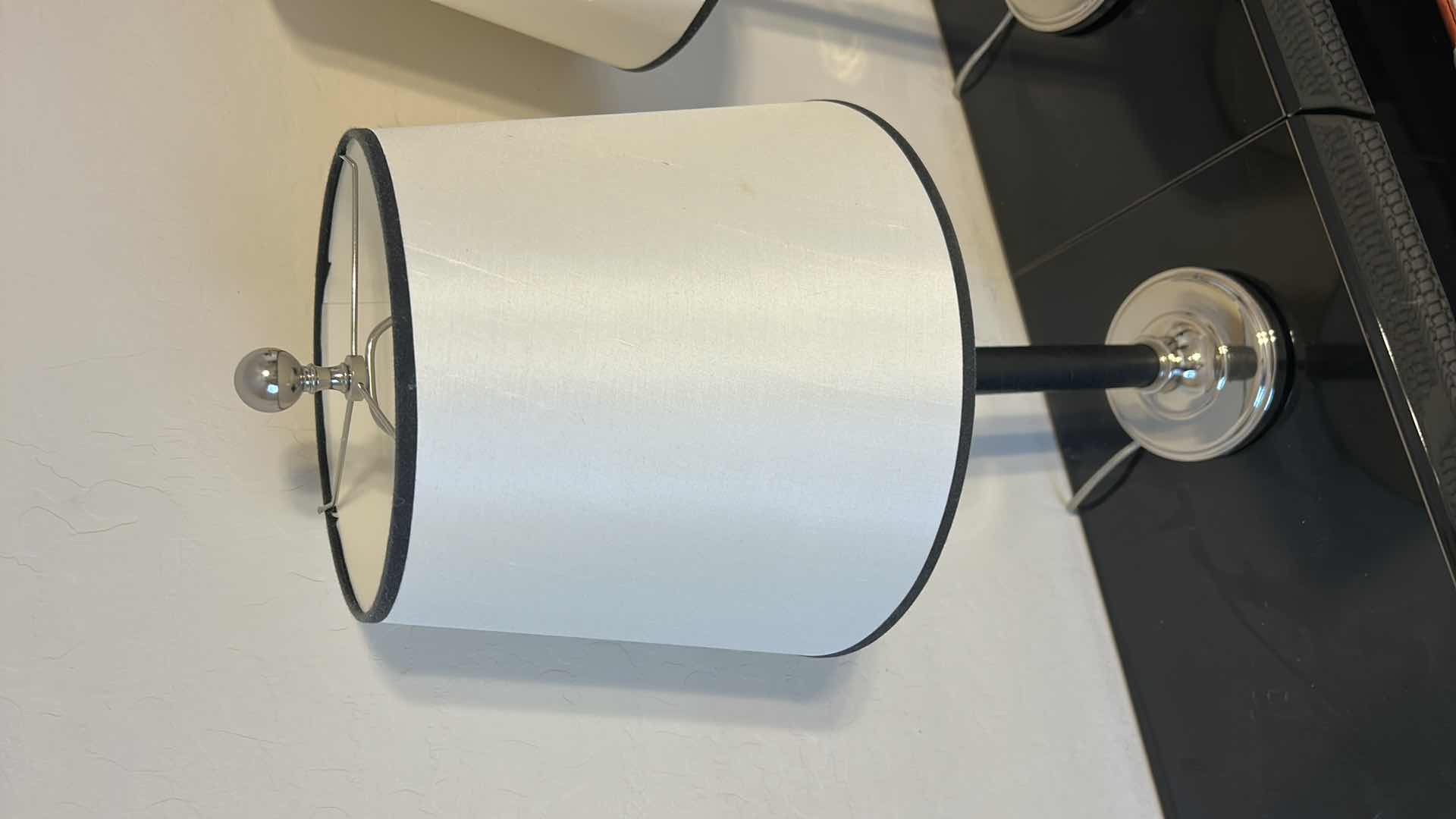 Photo 1 of 2 - BLACK LEATHER WRAPPED WITH SILVER ACCENTS AND BLACK OUTLINED WHITE SHADESTABLE LAMP  H28”