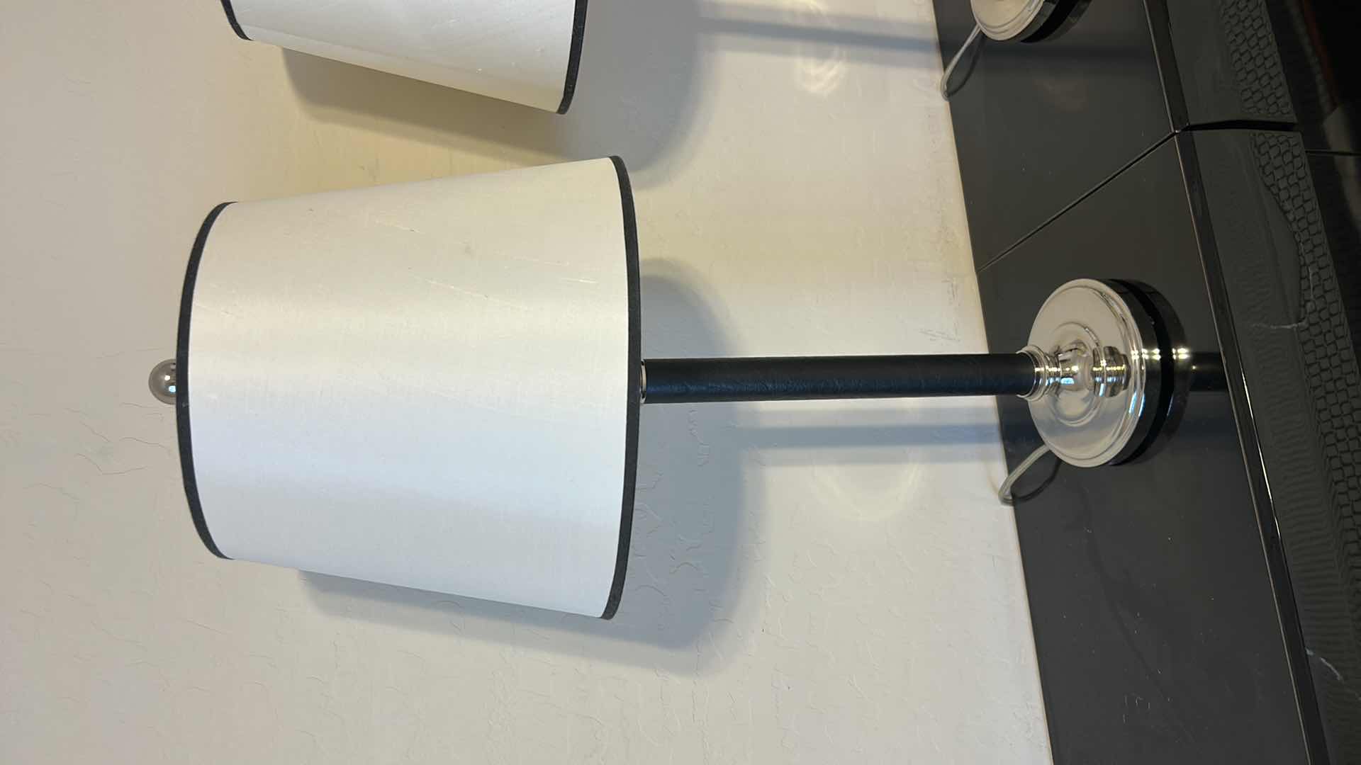 Photo 1 of 2 - BLACK LEATHER WRAPPED WITH SILVER ACCENTS AND BLACK OUTLINED WHITE SHADESTABLE LAMP  H28”