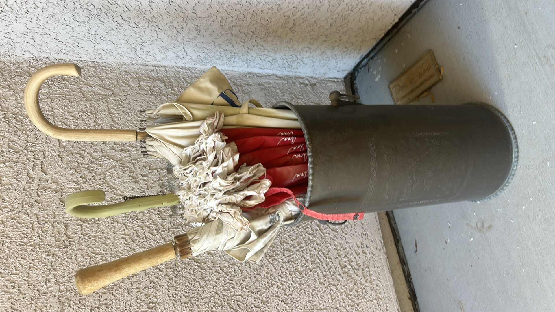 Photo 1 of METAL UMBRELLA STAND WITH VINTAGE AVON UMBRELLAS