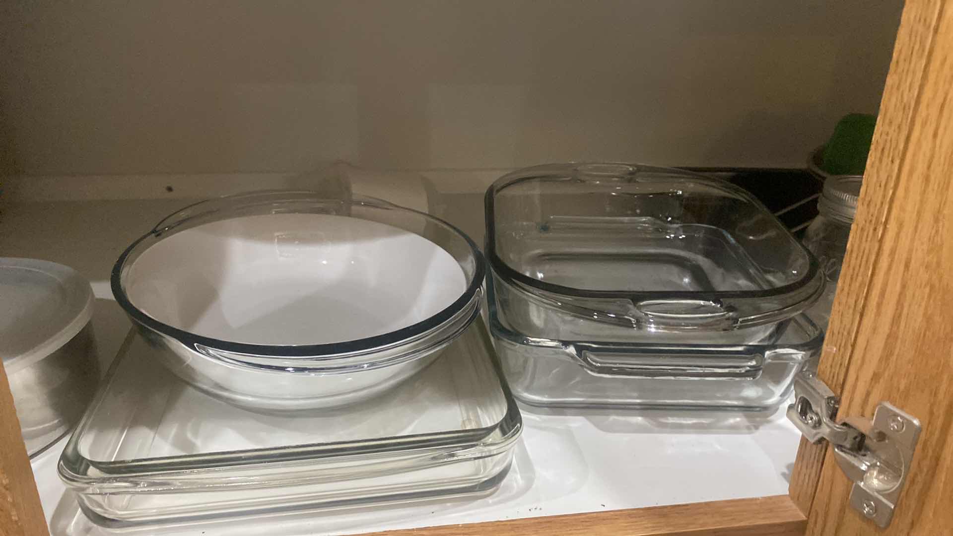 Photo 1 of CONTENTS OF CABINET - GLASS BAKEWARE & PLASTIC COLANDERS & MORE