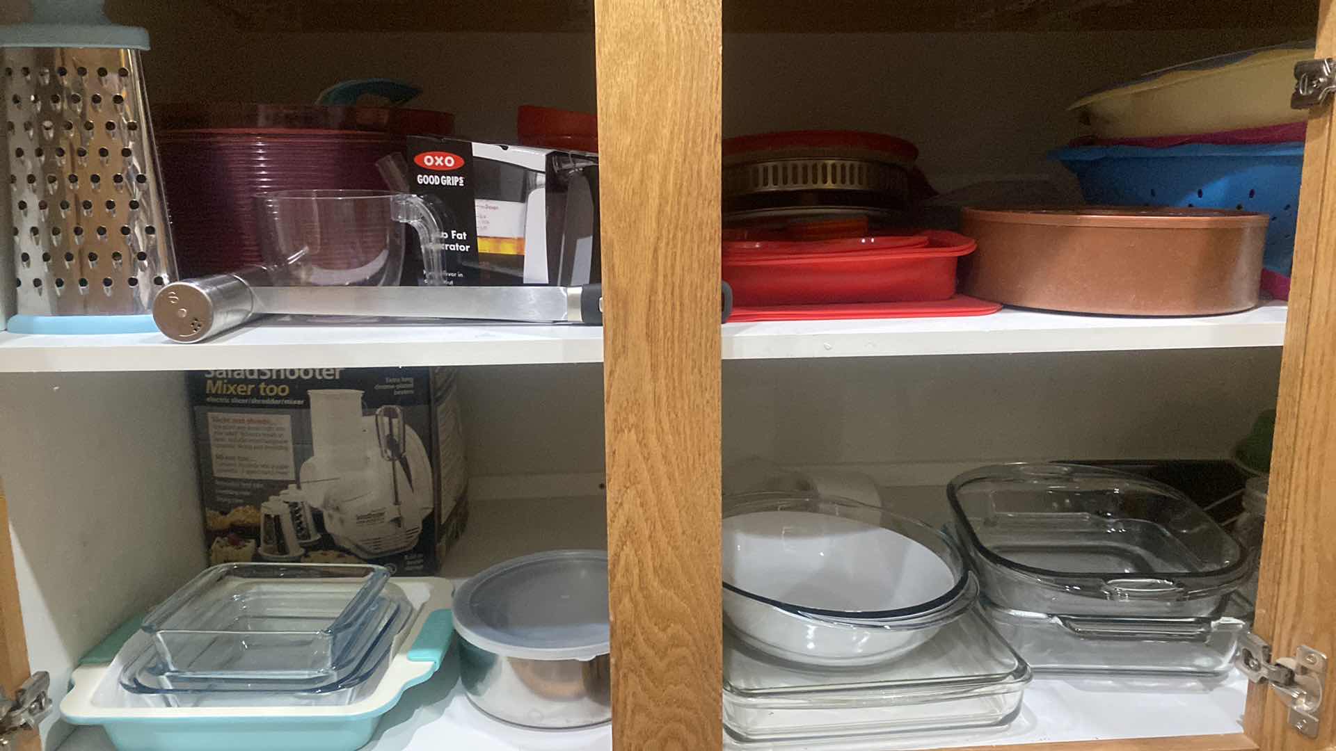 Photo 1 of CONTENTS OF CABINET - GLASS BAKEWARE & PLASTIC COLANDERS & MORE