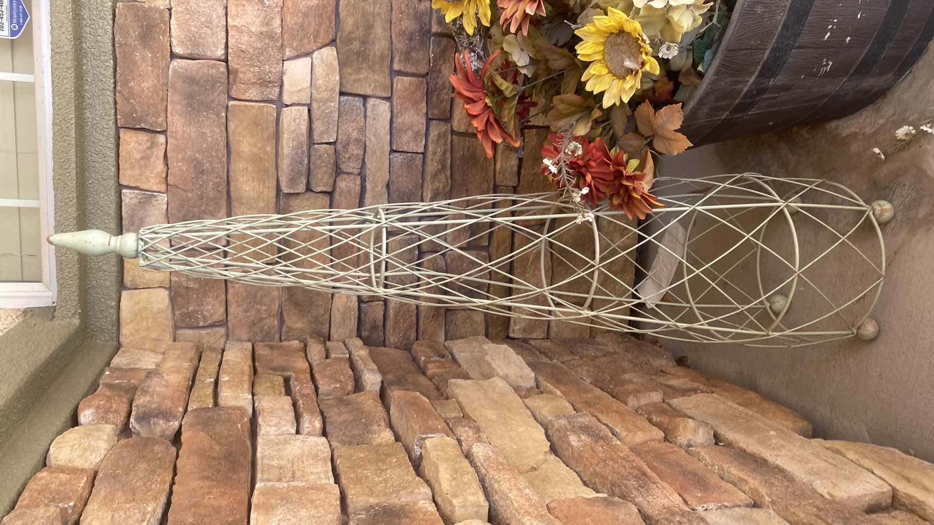 Photo 1 of PLASTIC BARREL POT WITH FAUX FLOWERS & GREEN METAL DECOR H44”