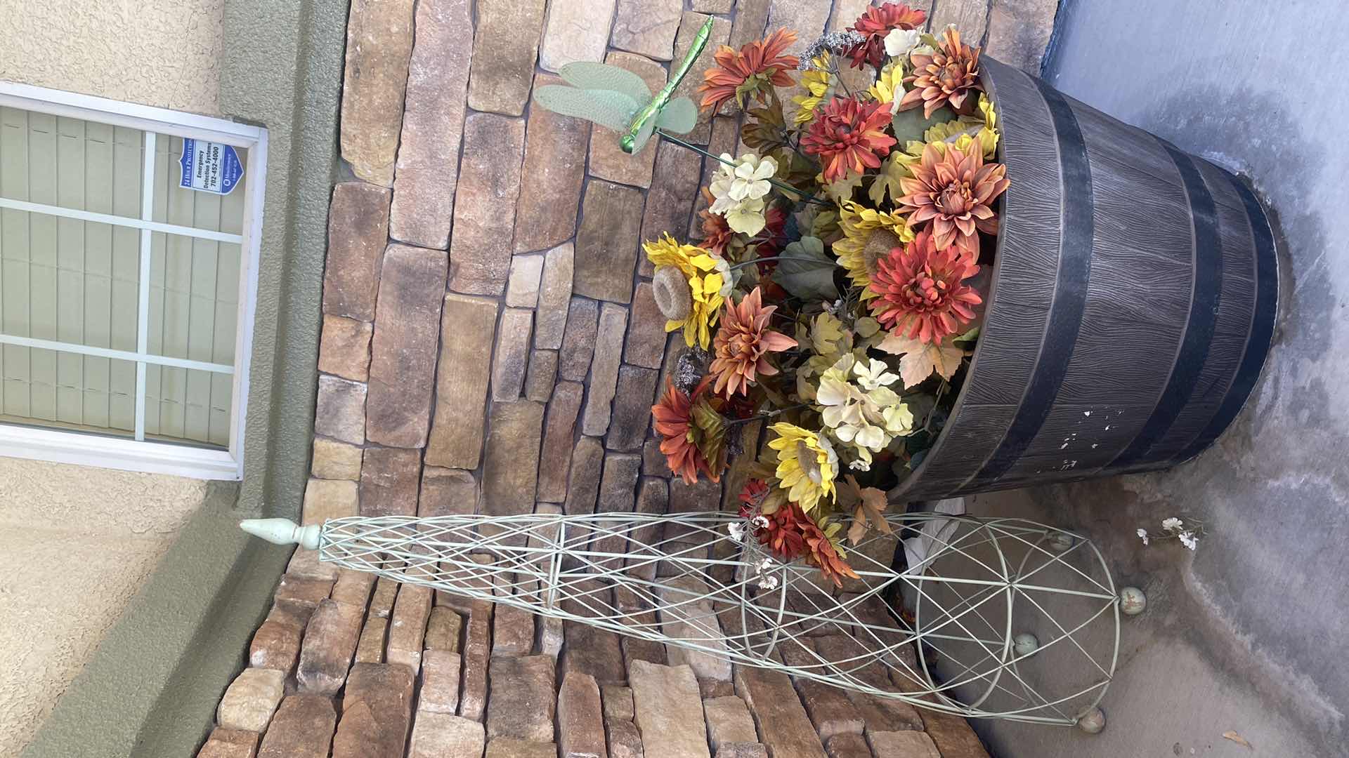 Photo 1 of PLASTIC BARREL POT WITH FAUX FLOWERS & GREEN METAL DECOR H44”