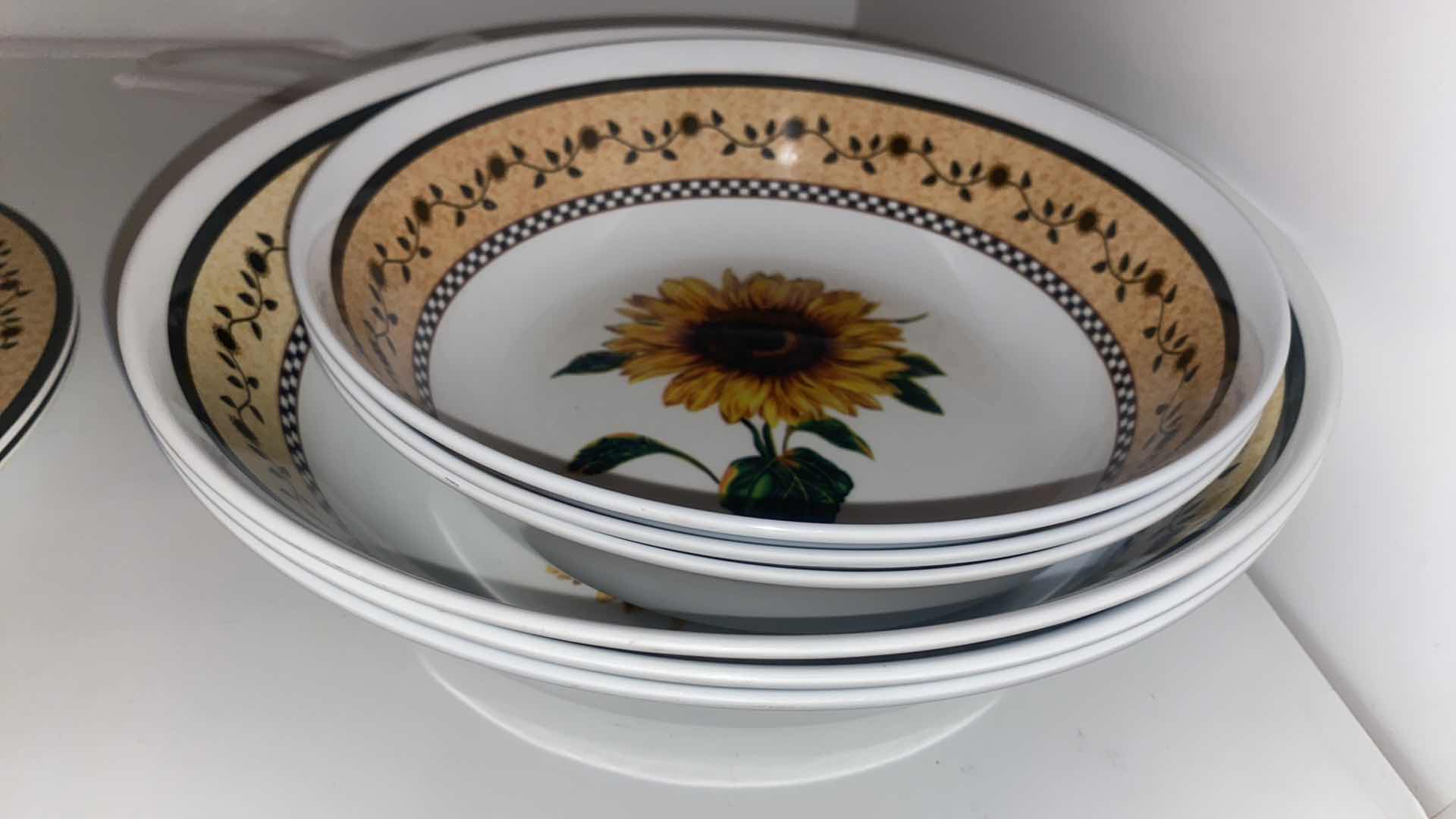 Photo 1 of CONTENTS OF CABINET -  MELAMINE  SUNFLOWER SERVE WARE & CERAMIC FRUIT MOTIF SERVE WARE
