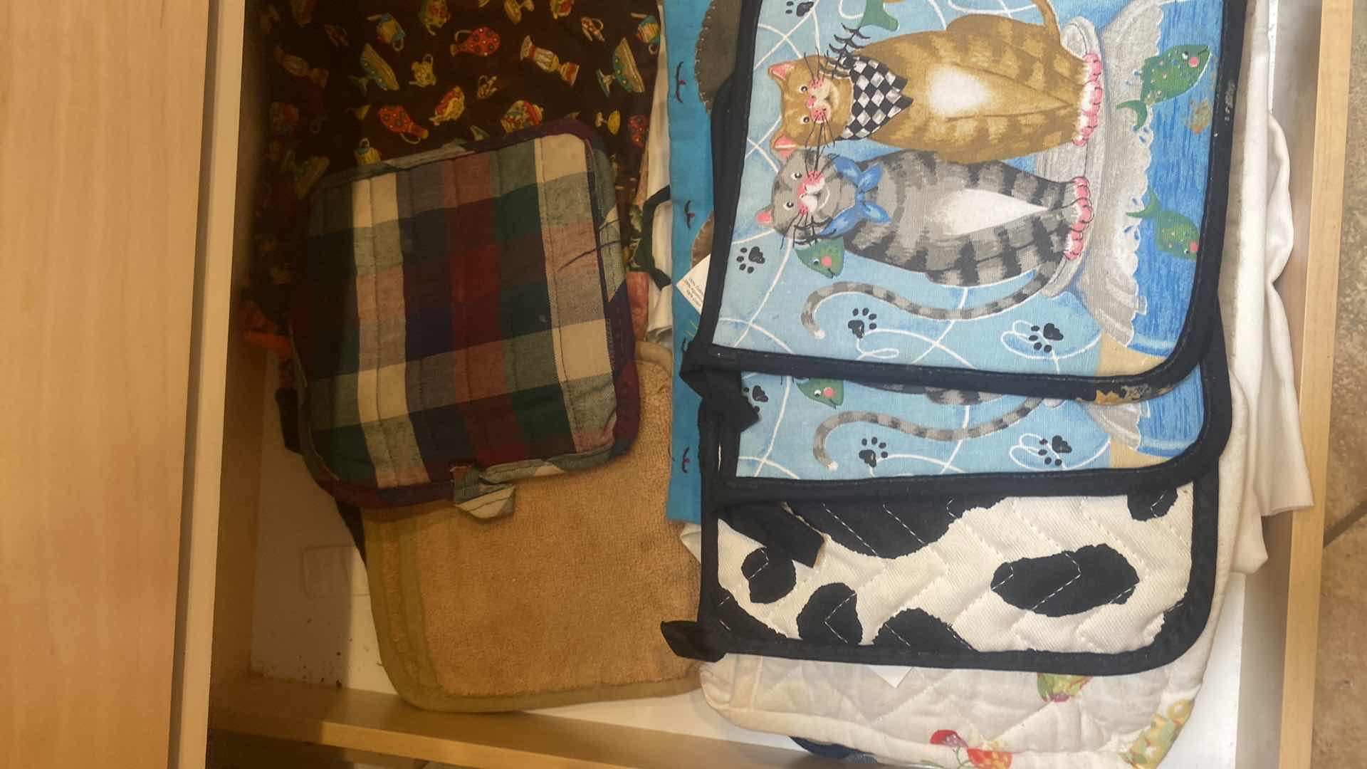 Photo 1 of CONTENTS OF CABINET-DISH TOWELS & POT HOLDERS