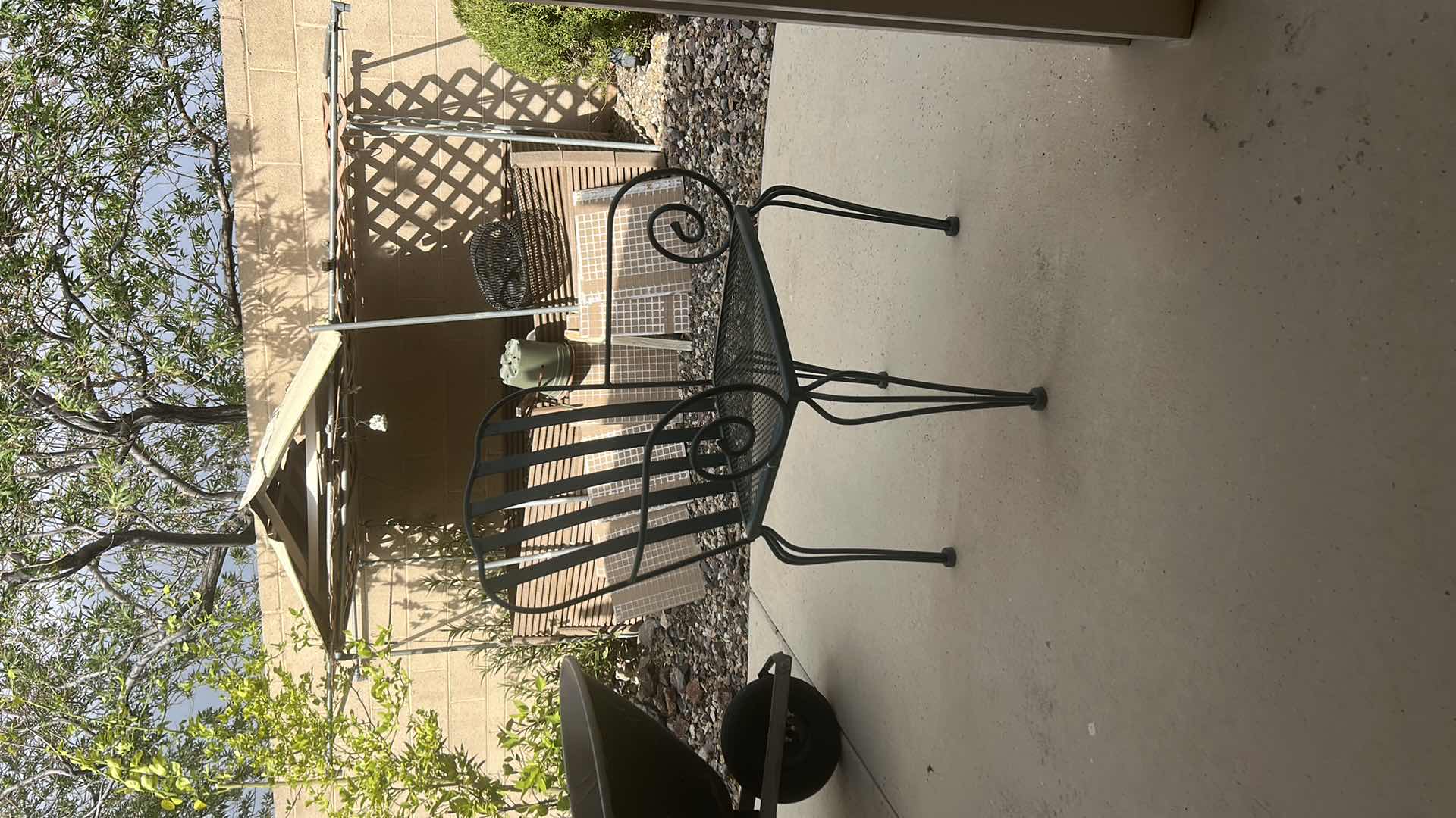 Photo 1 of 2 VINTAGE WROUGHT-IRON PATIO ARMCHAIR, FEATURING A MESH SEAT AND SCROLL ARM DETAILS $400 - $500