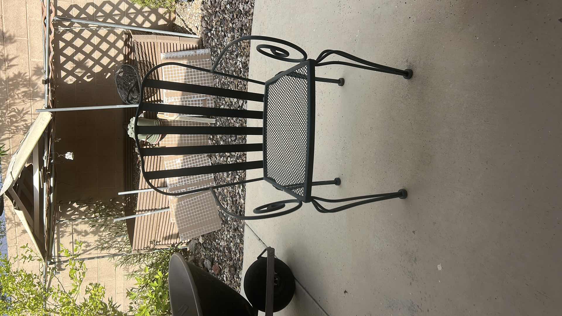 Photo 1 of 2 VINTAGE WROUGHT-IRON PATIO ARMCHAIR, FEATURING A MESH SEAT AND SCROLL ARM DETAILS $400 - $500