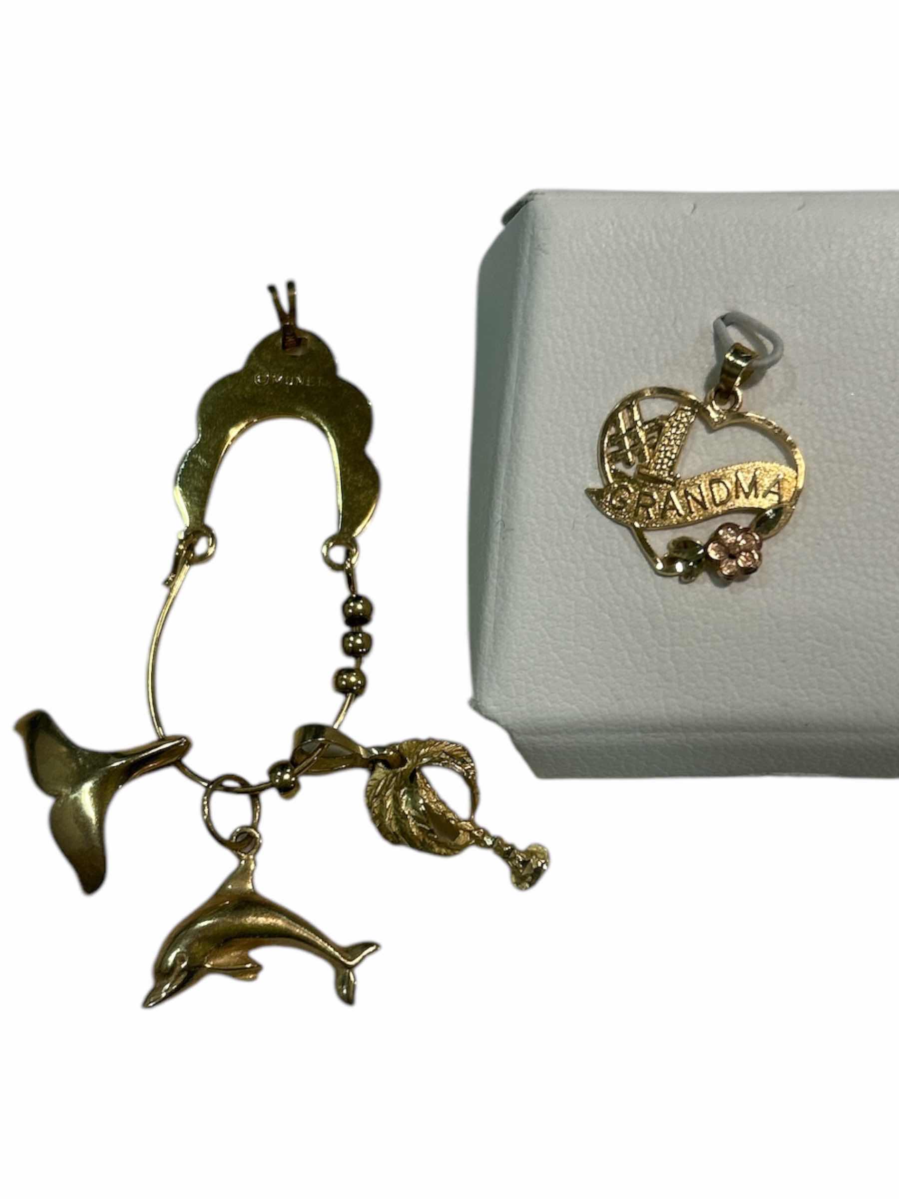 Photo 1 of MONET CHARM HOLDER PENDANT AND 4 CHARMS (3 ARE 14K, (COULD NOT FIND STAMP ON PALM TREE)