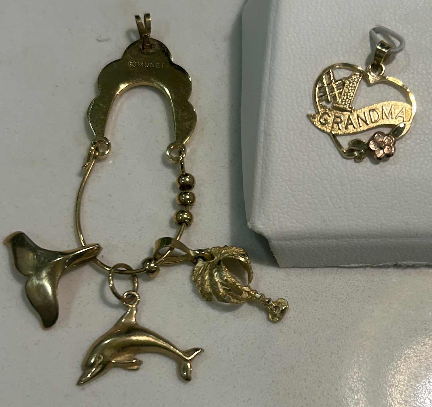 Photo 2 of MONET CHARM HOLDER PENDANT AND 4 CHARMS (3 ARE 14K, (COULD NOT FIND STAMP ON PALM TREE)