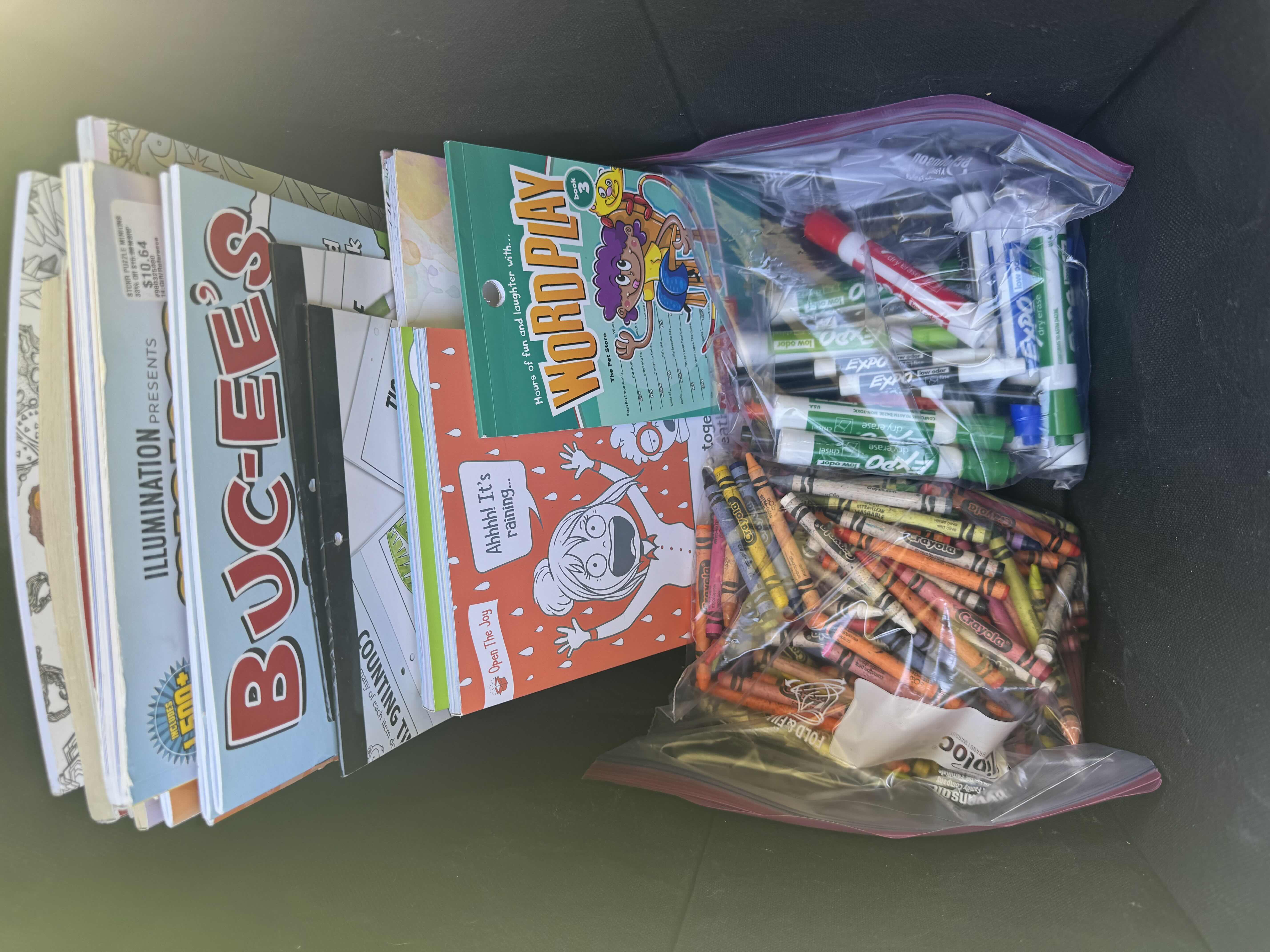 Photo 1 of BLACK TOTE WITH ASSORTED ACTIVITY BOOKS, CRAYONS, AND DRY ERASE MARKERS 

TOTE 
14.5” X 12.5” H12.5”