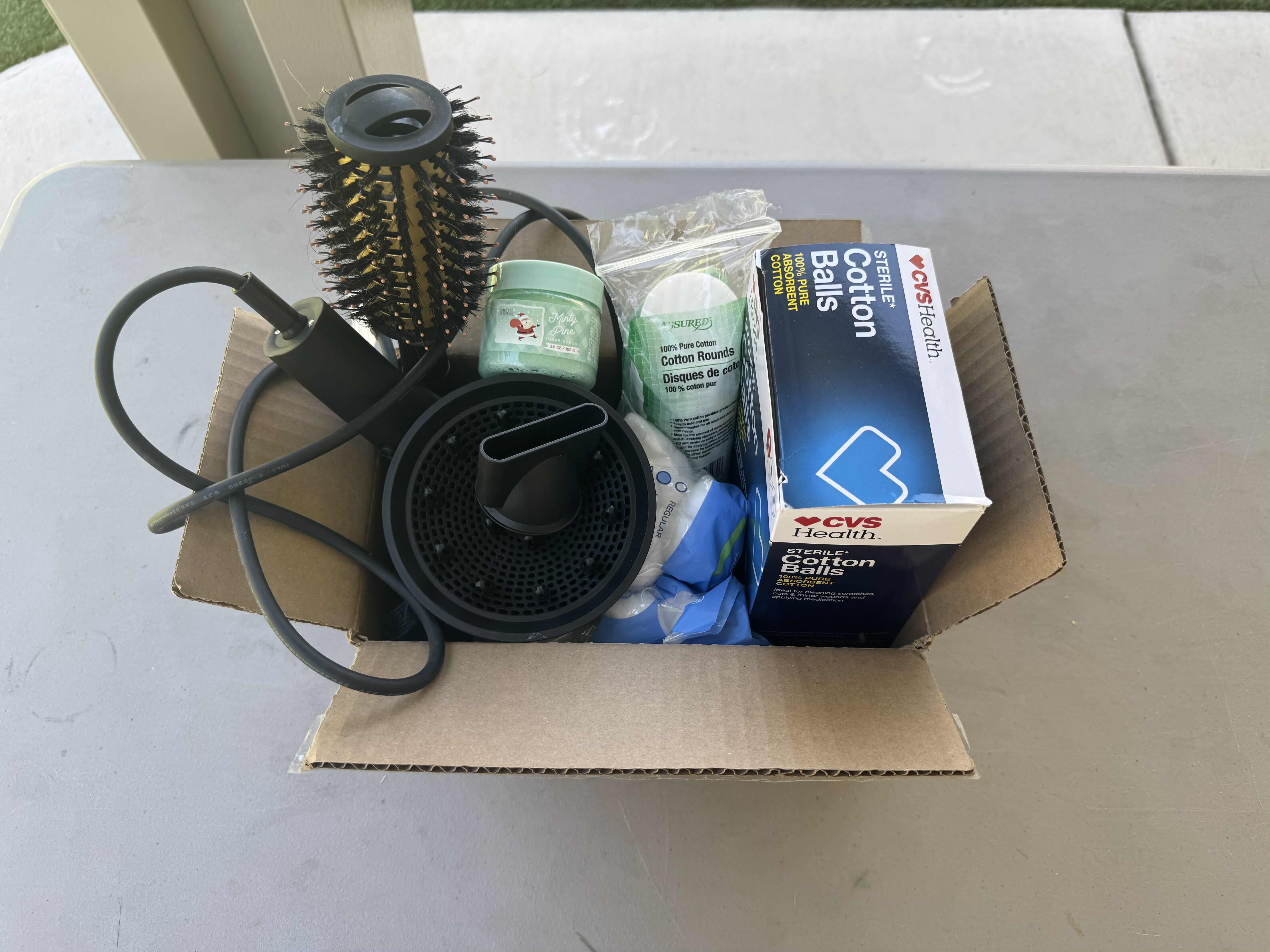 Photo 1 of BOX WITH CONTENTS OF BATHROOM CABINET, BLOWDRYER, BLOWDRYER ACCESSORIES, COTTON BALLS, COTTON ROUNDS, SUGAR SCRUB, ROUND BRUSH