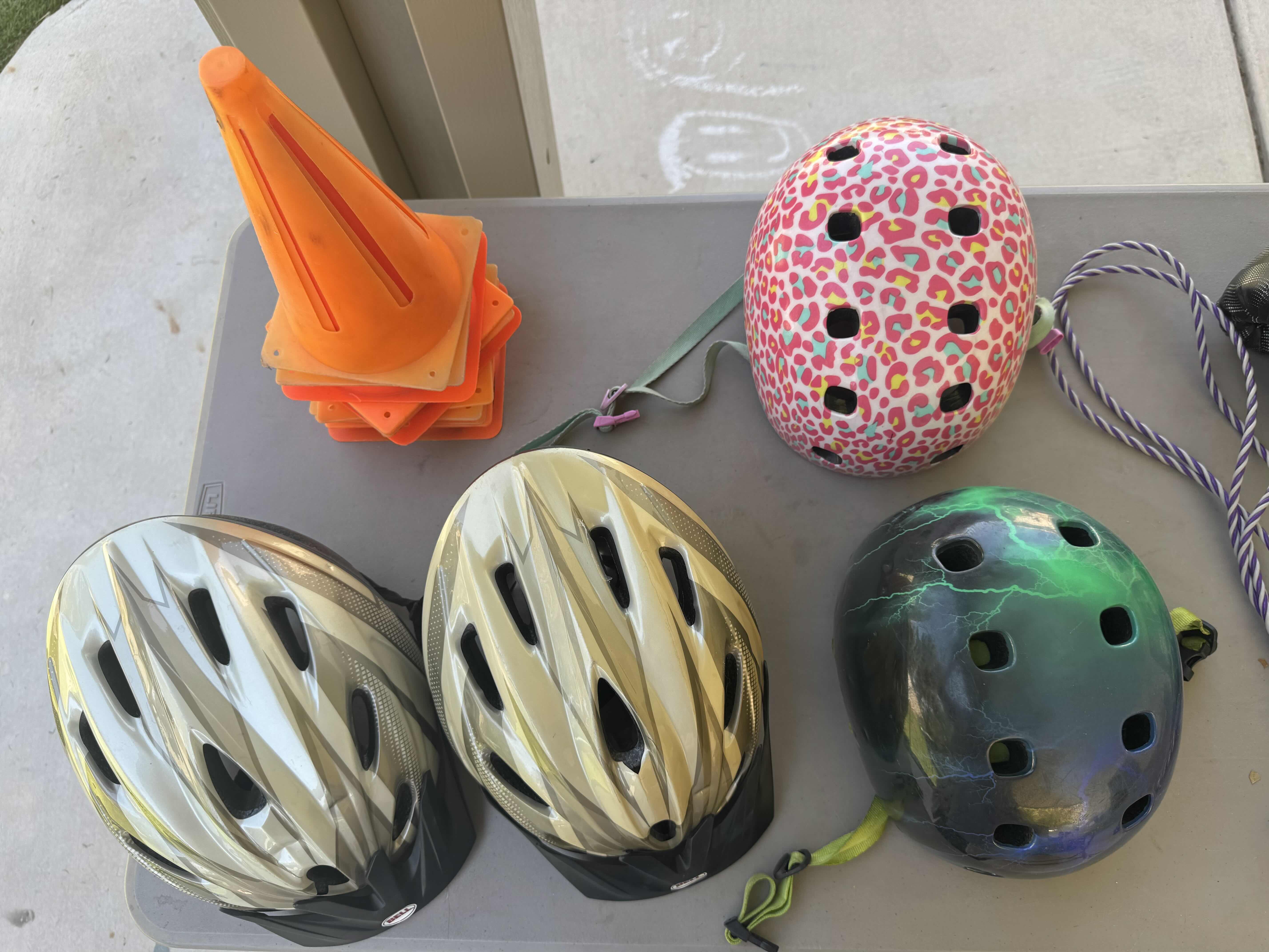 Photo 1 of ASSORTED HELMETS, ORANGE CONES, JUMPROPE, 2 PAIRS OF BOXING GLOVES, OUTDOOR ACTIVITIES
*TABLE NOT INCLUDED*