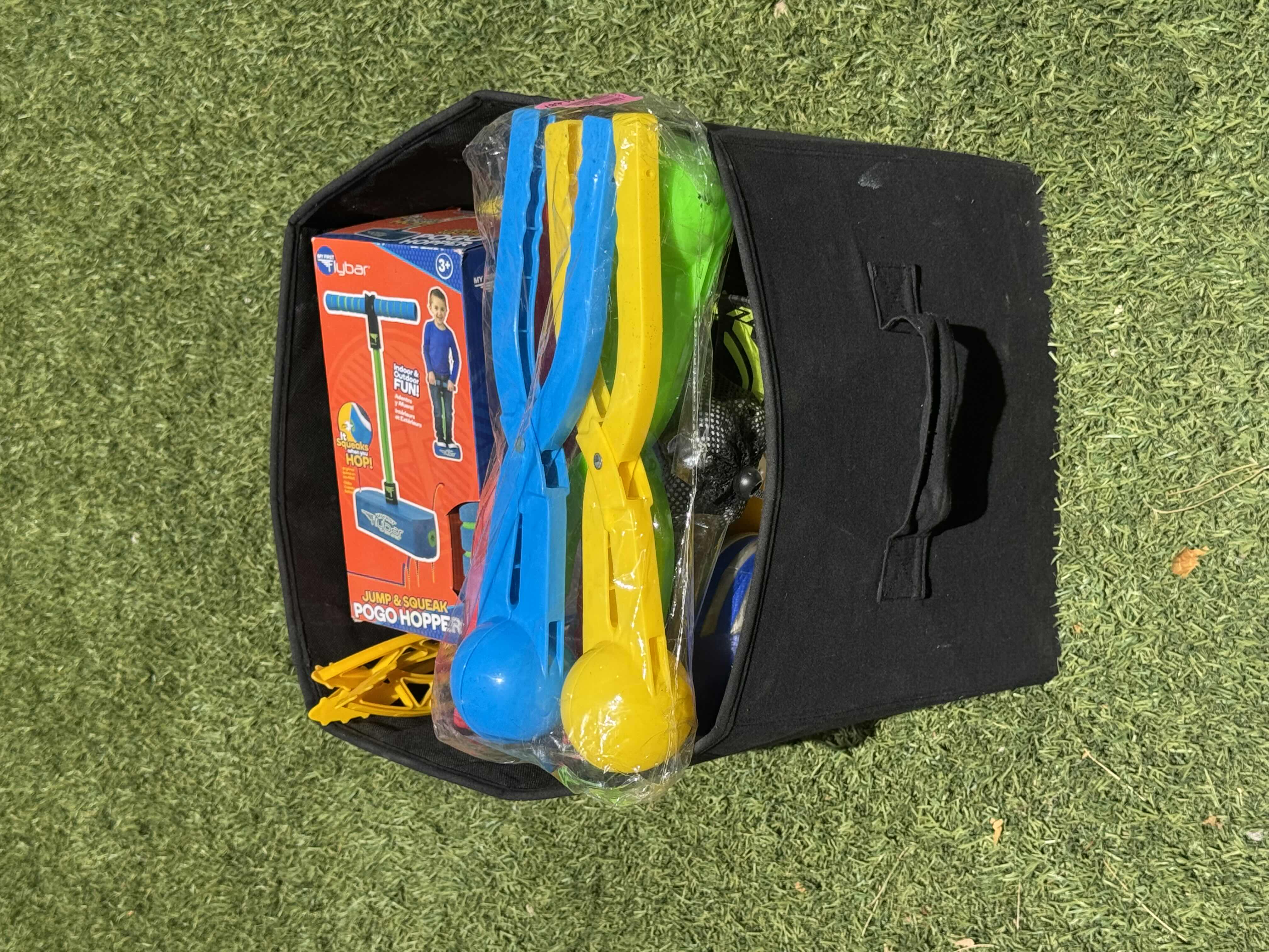 Photo 4 of TOTE OF OUTDOOR ACTIVITIES, KIDS GAMES ACTIVITIES, STOMP ROCKETS, JUMP AND SQUEAK, NERF FOOTBALL, NEON HEEL SKATES, WIFFLE PLASTIC PRACTICE GOLF BALLS, GOLF BALLS, SNOWBALL MAKERS

TOTE 
15” X 13” X H13”