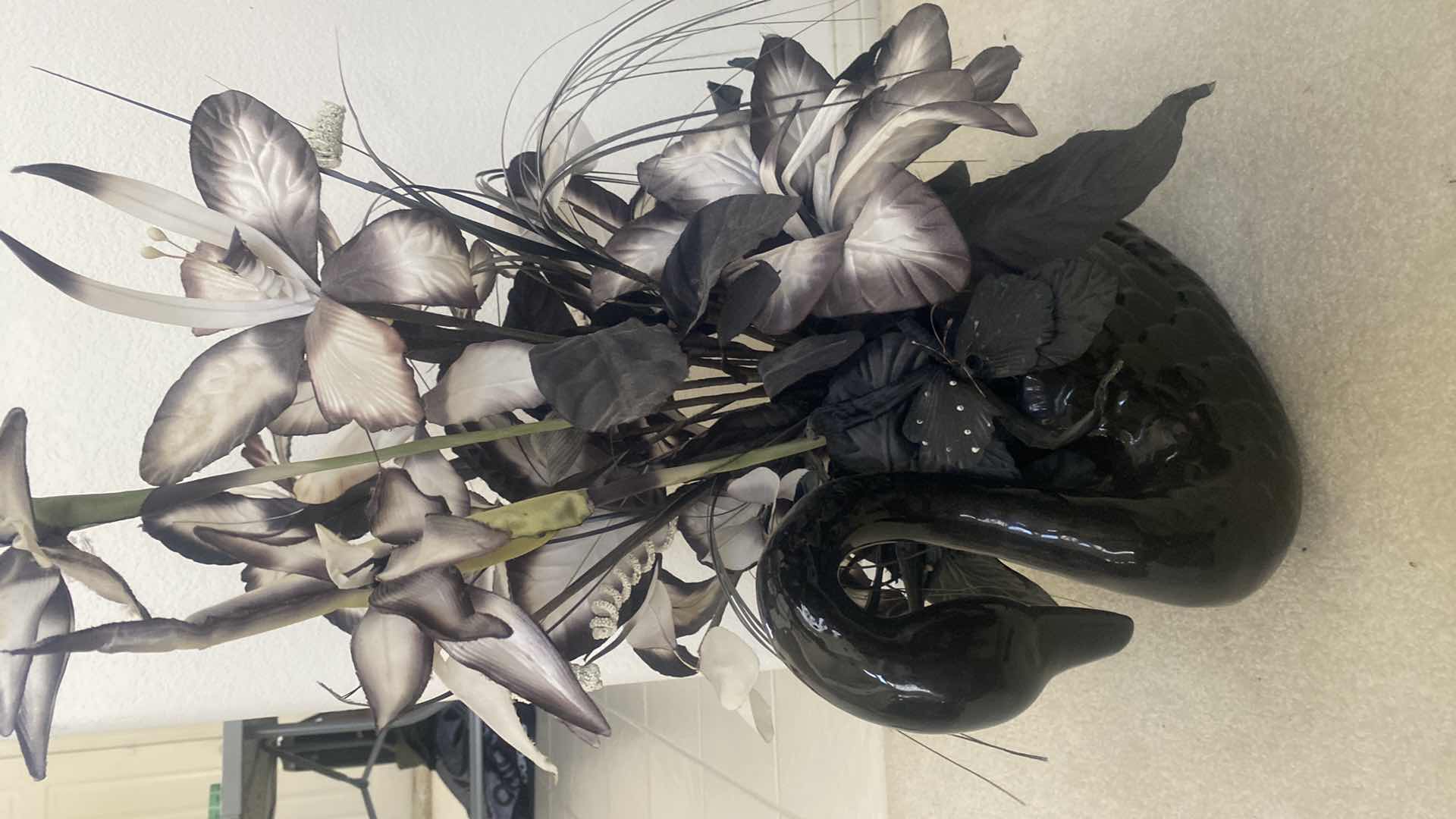 Photo 1 of BLACK CERAMIC SWAN WITH FAUX FLORALS OVERALL 19“ x 29“