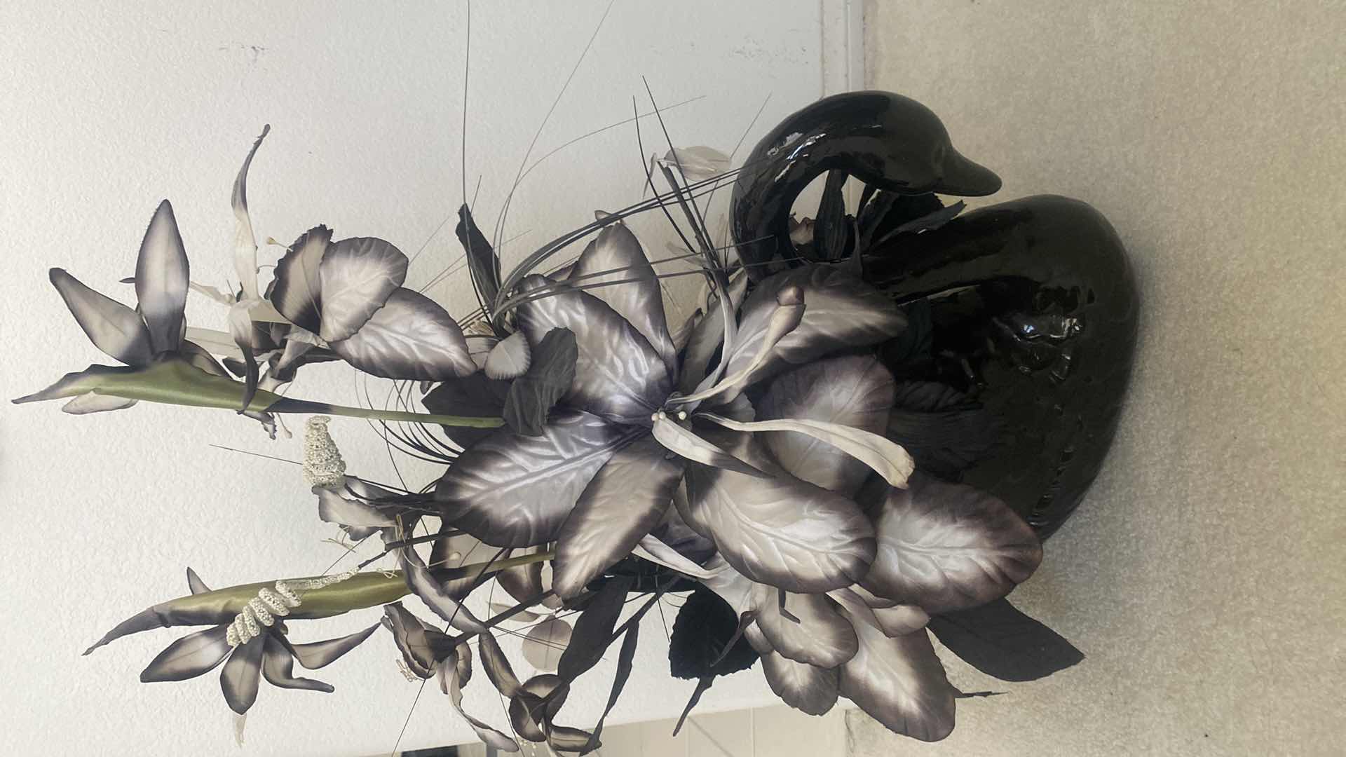 Photo 1 of BLACK CERAMIC SWAN WITH FAUX FLORALS OVERALL 19“ x 29“