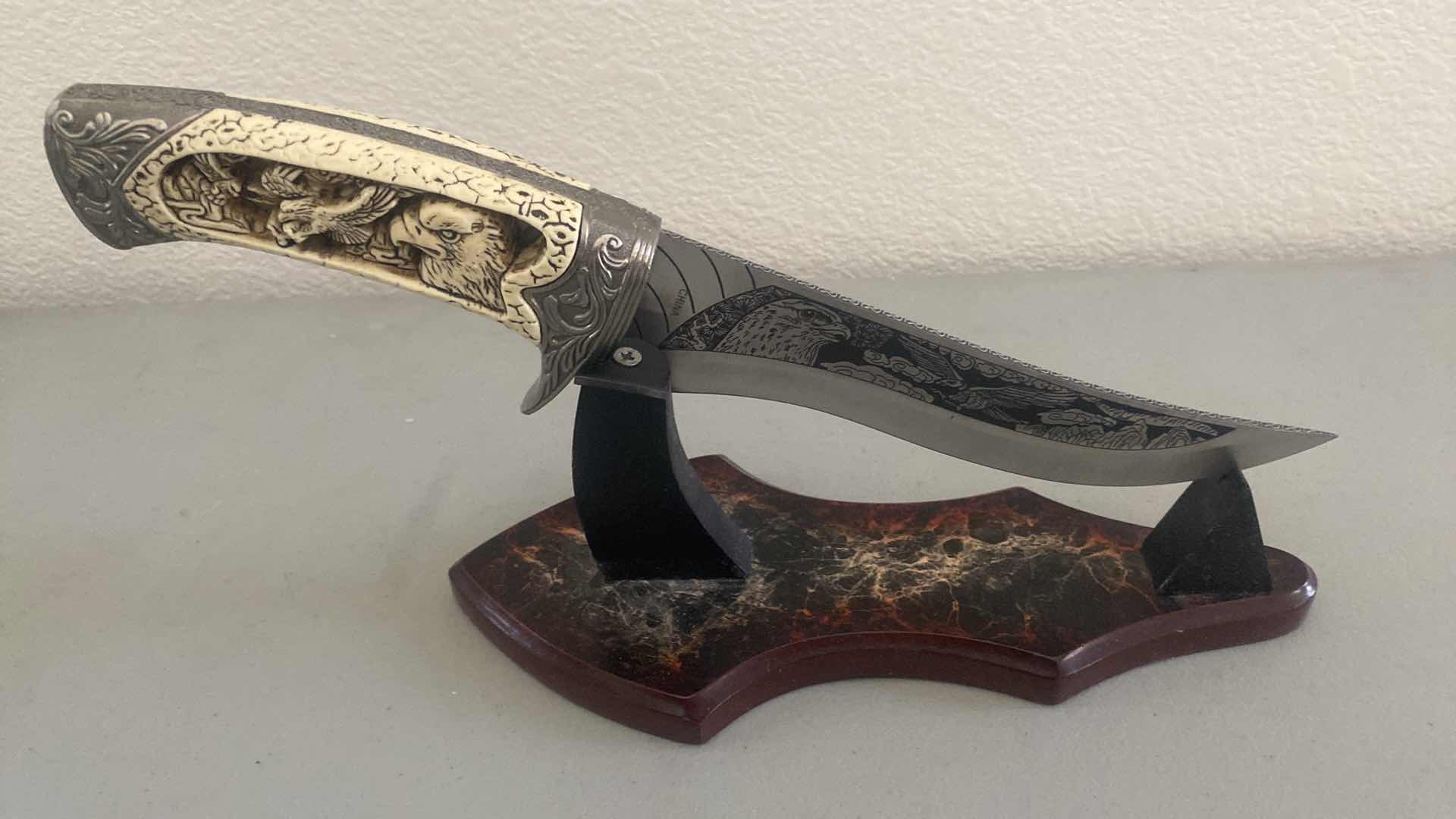 Photo 1 of CARVED HUNTING KNIFE ON STAND 12”