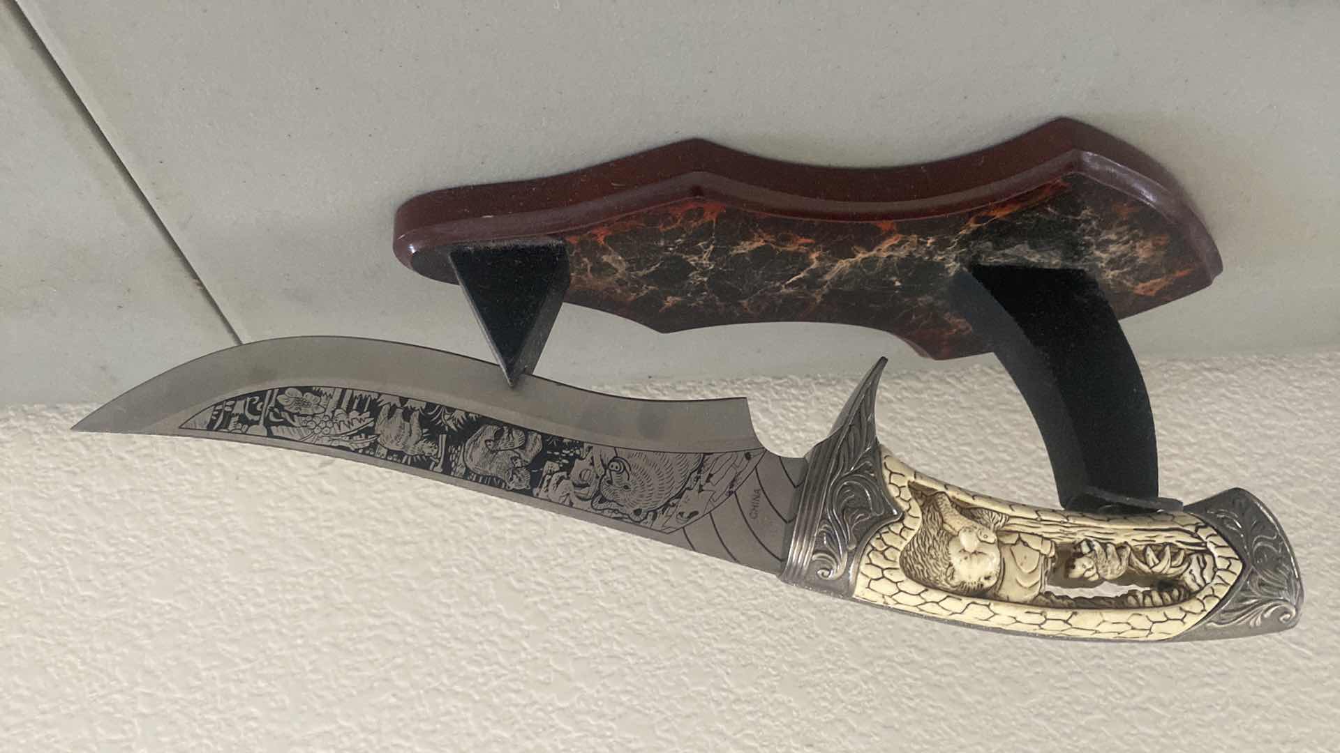 Photo 1 of CARVED HUNTING KNIFE ON STAND 12”