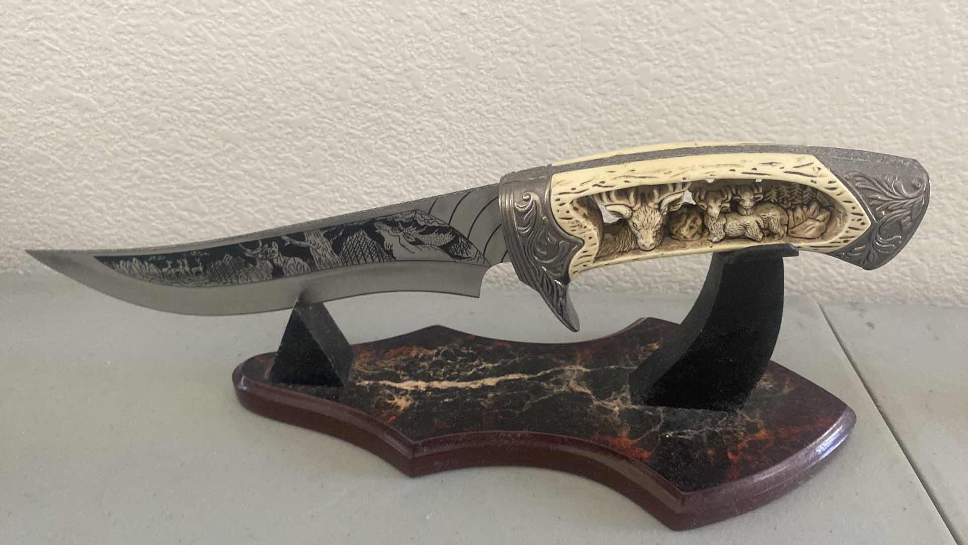 Photo 1 of CARVED HUNTING KNIFE ON STAND 12”