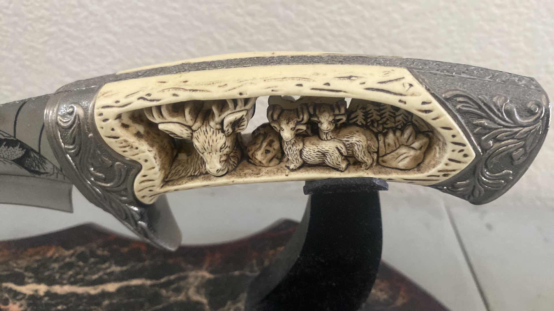 Photo 1 of CARVED HUNTING KNIFE ON STAND 12”