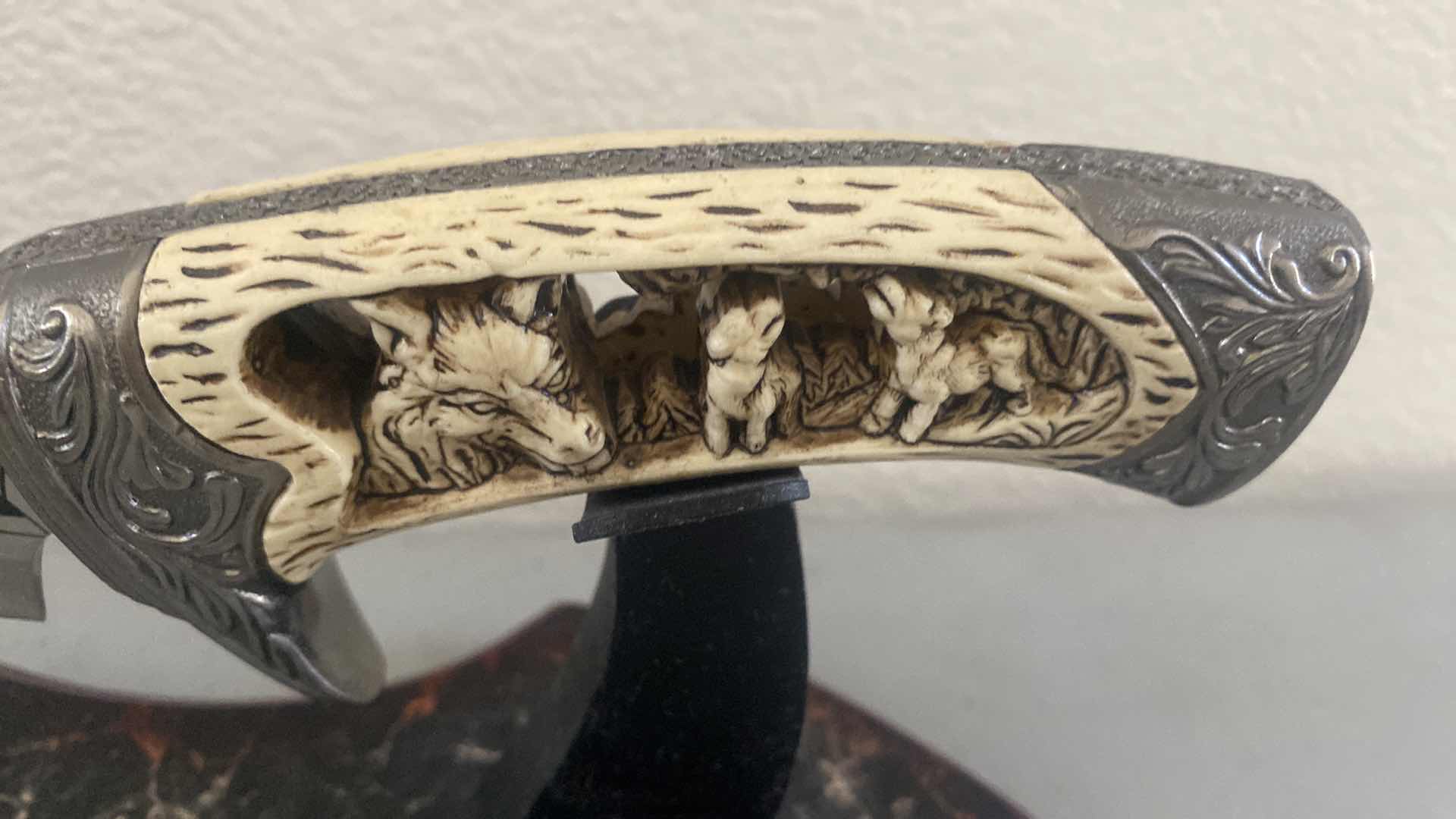 Photo 1 of CARVED HUNTING KNIFE ON STAND 12”