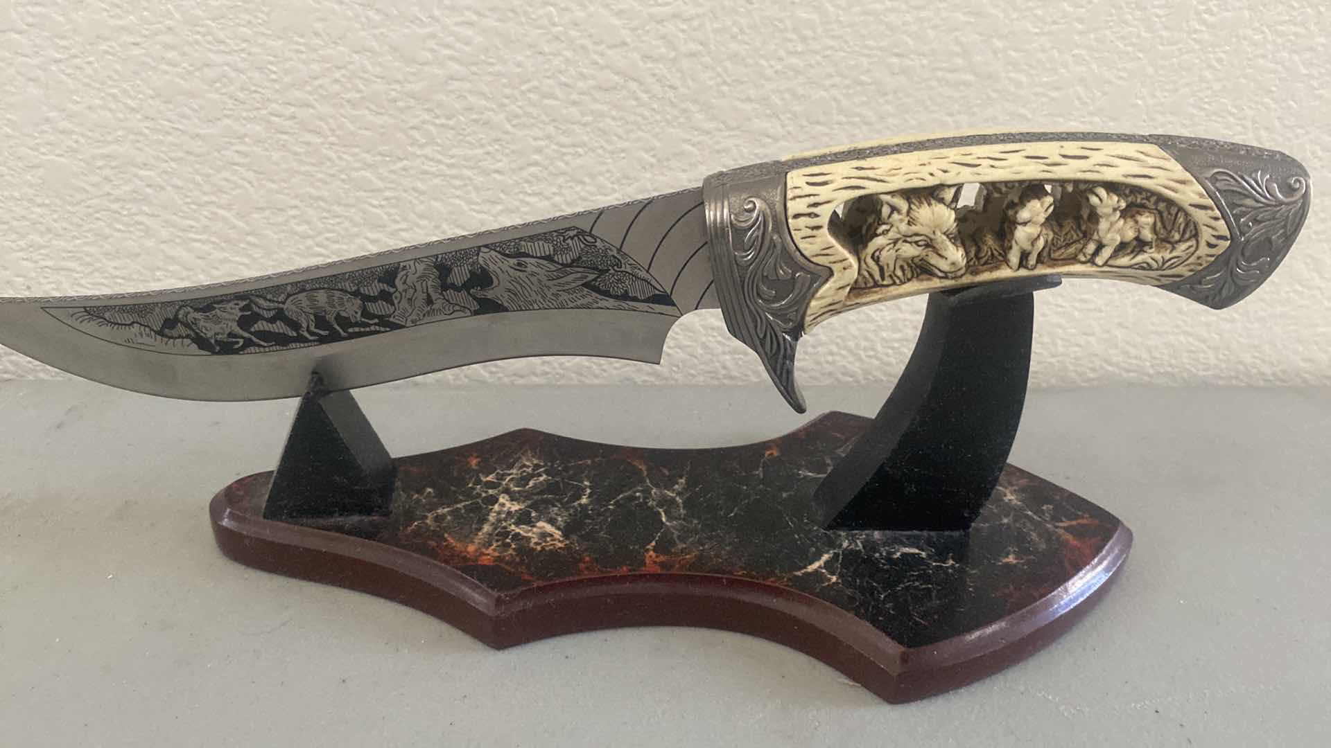 Photo 2 of CARVED HUNTING KNIFE ON STAND 12”