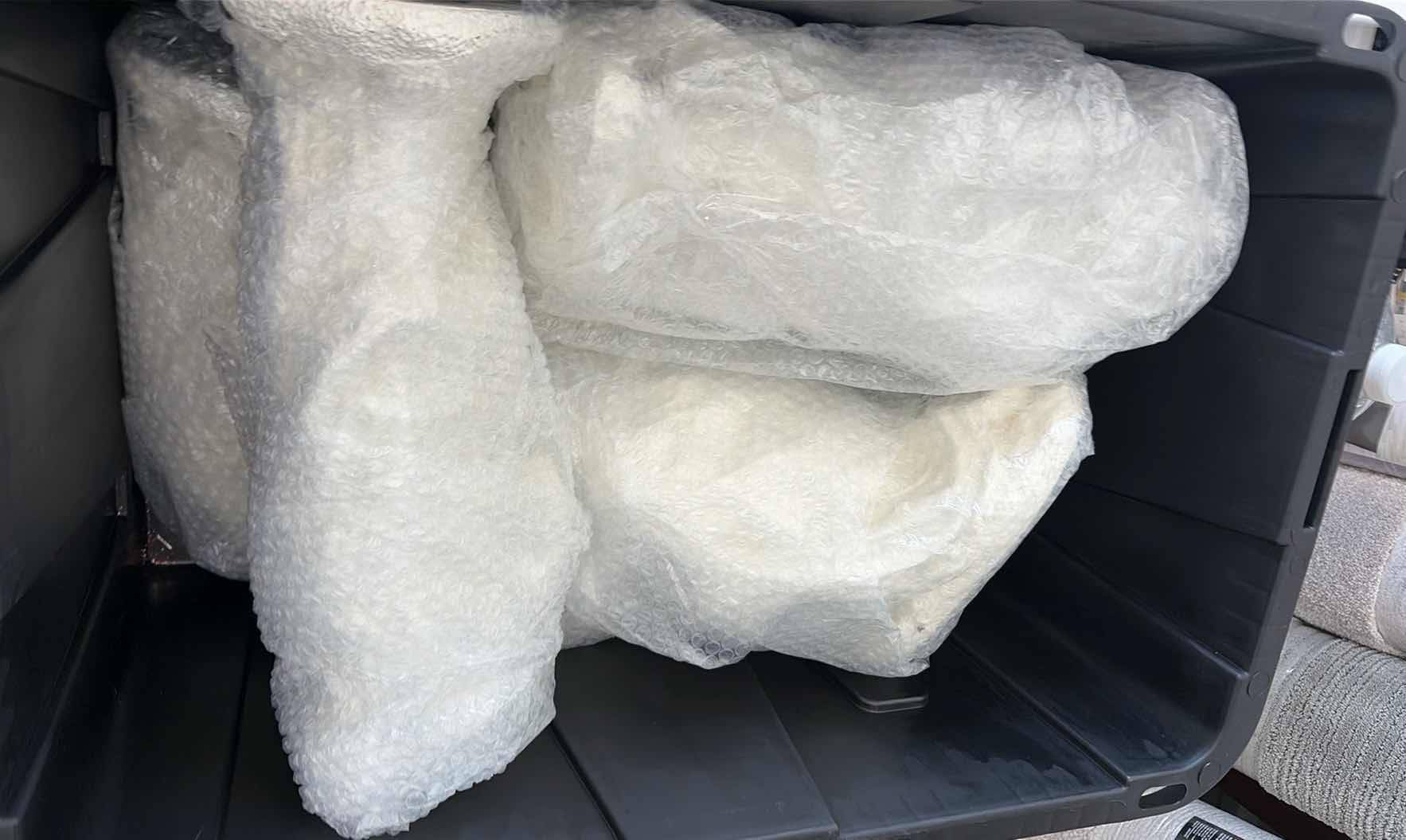 Photo 1 of CONTENTS OF TOTE- RELIGIOUS STATUES
