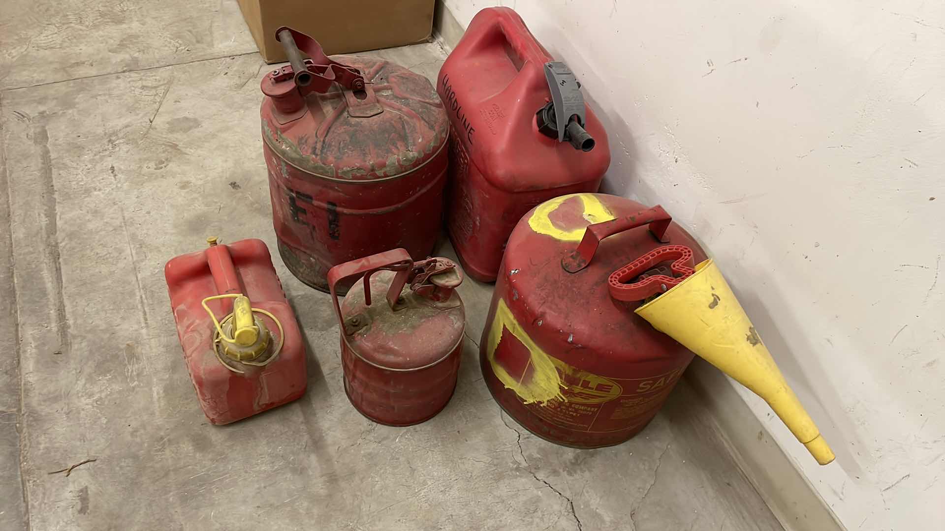 Photo 1 of GAS CANS 2 HAVE SOME LIQUID IN THEM.