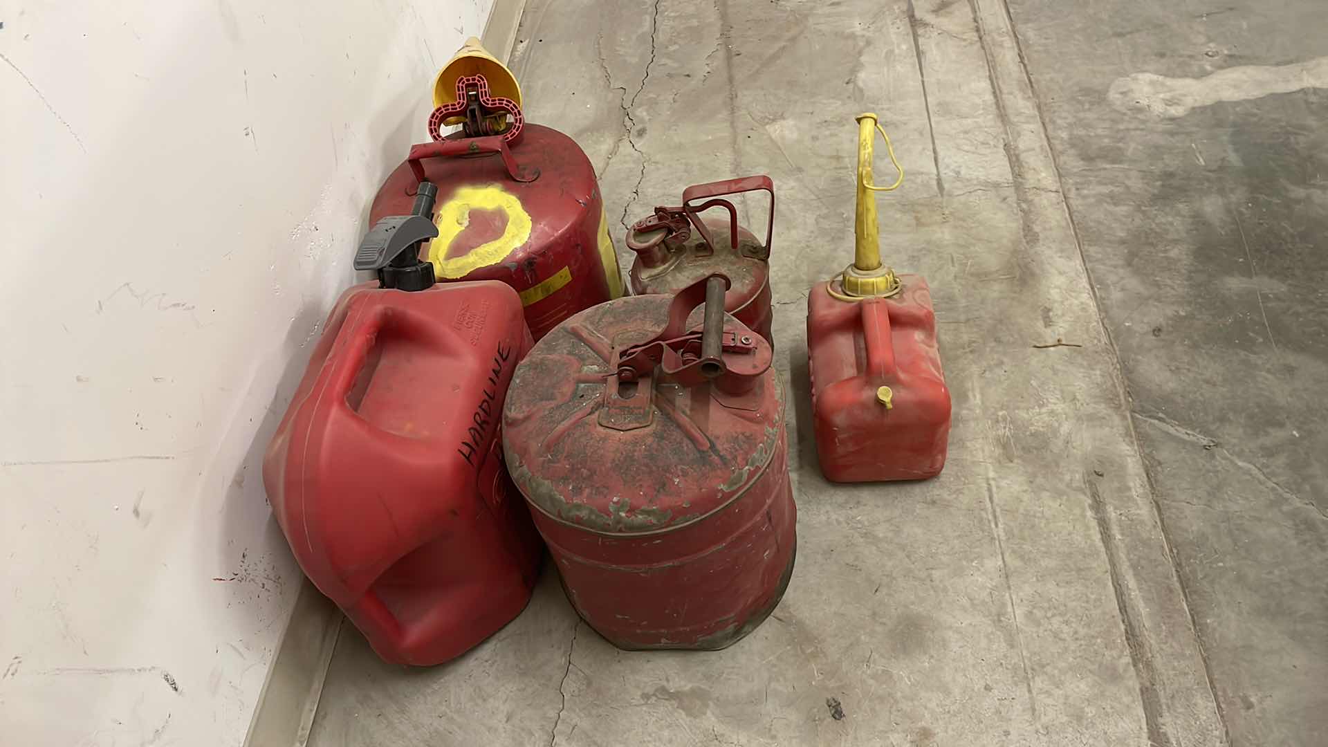 Photo 1 of GAS CANS 2 HAVE SOME LIQUID IN THEM.