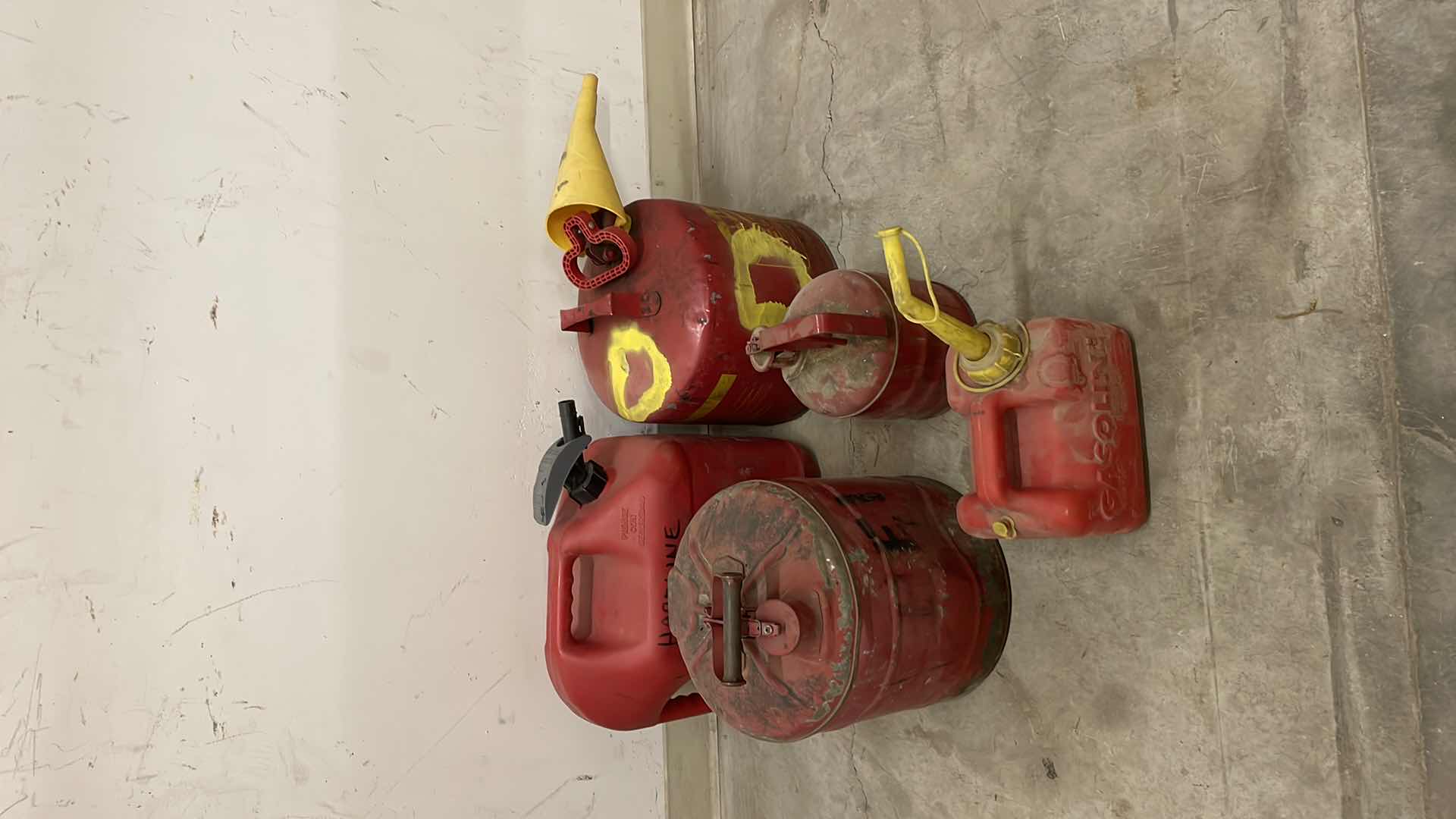 Photo 1 of GAS CANS 2 HAVE SOME LIQUID IN THEM.