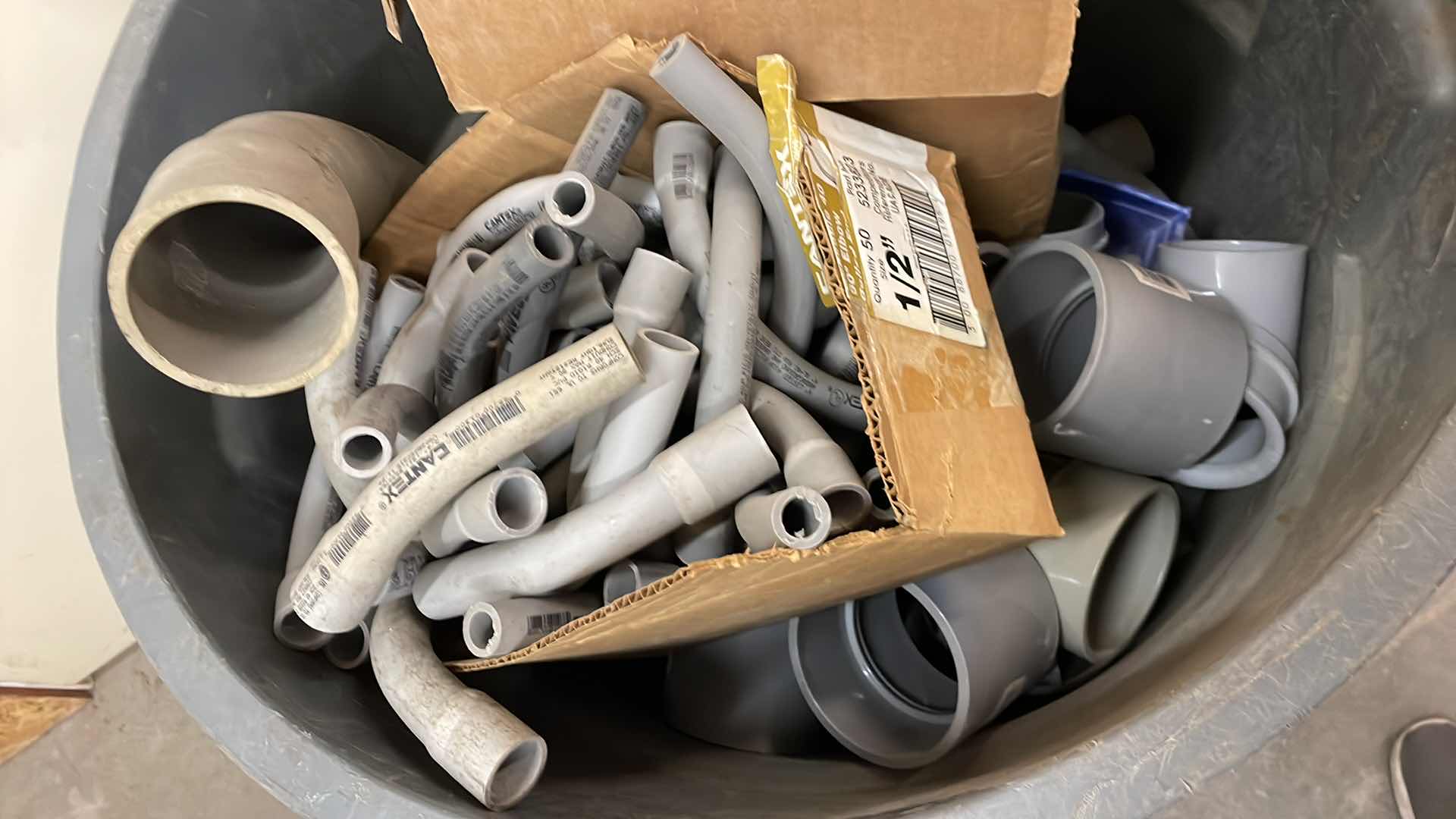 Photo 1 of BRUTE RUBBERMAID 55 GAL TRASH CAN FULL OF A VARIETY OF SCHEDULE 40 PVC 3/4”-3” ELBOWS, COUPLING, ADAPTERS,