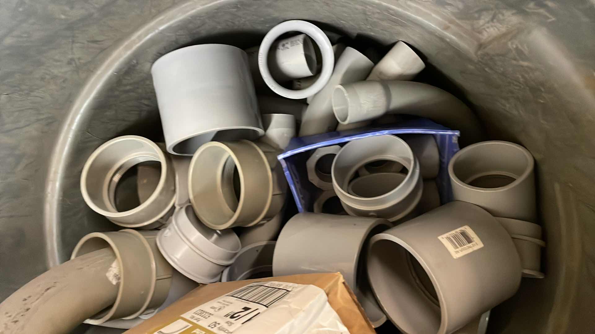 Photo 1 of BRUTE RUBBERMAID 55 GAL TRASH CAN FULL OF A VARIETY OF SCHEDULE 40 PVC 3/4”-3” ELBOWS, COUPLING, ADAPTERS,