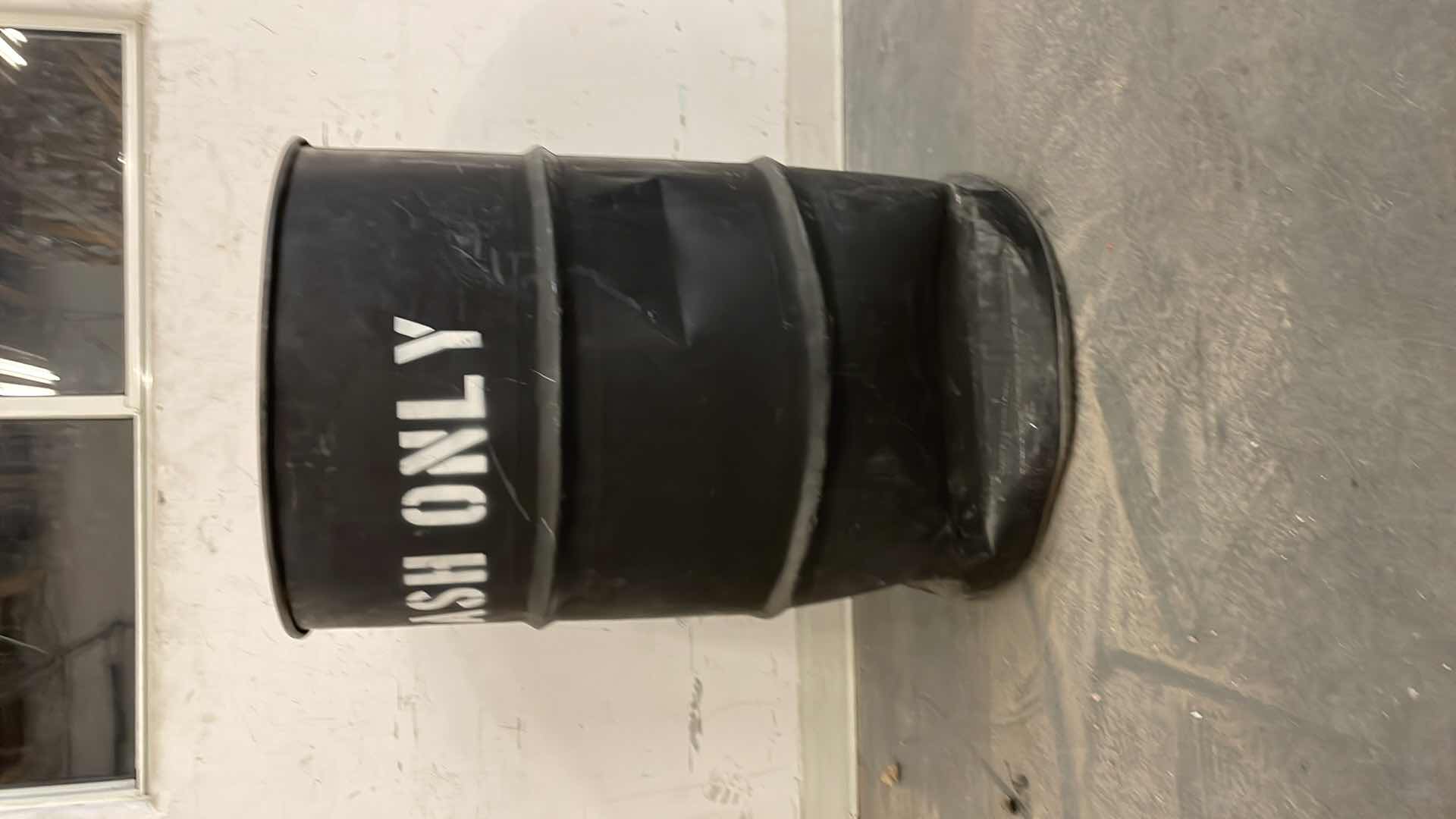 Photo 1 of 55 GALLON METAL TRASH CAN DENTED ON THE BOTTOM