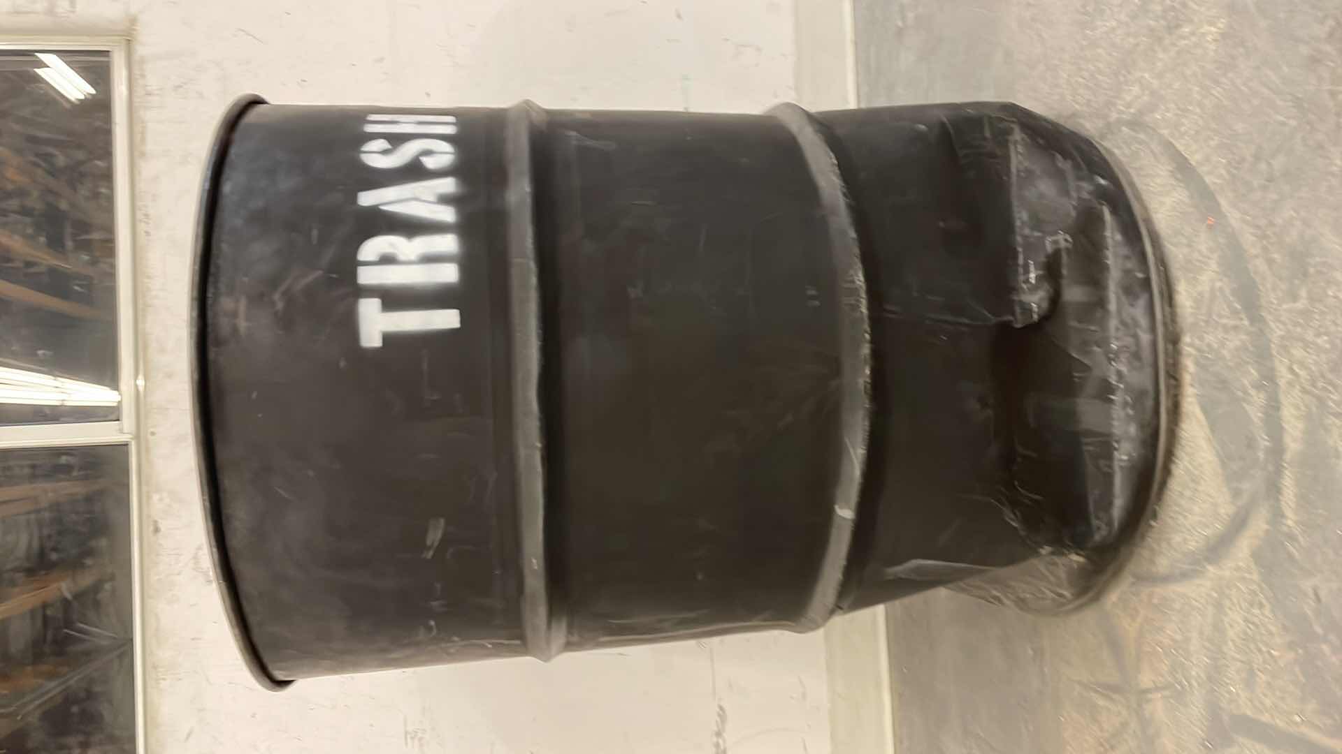 Photo 1 of 55 GALLON METAL TRASH CAN DENTED ON THE BOTTOM