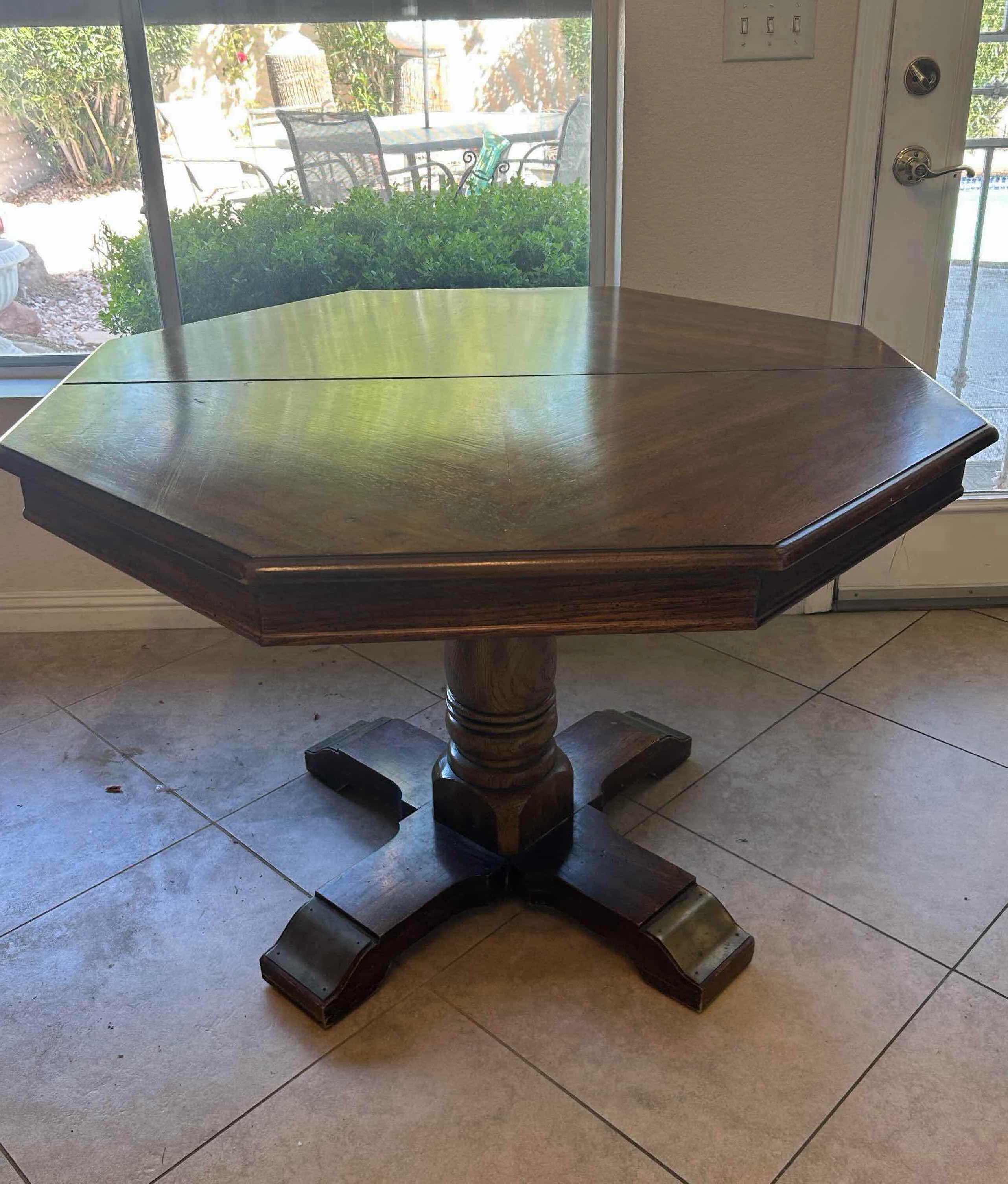 Photo 1 of VINTAGE SOLID WOOD OCTAGON PEDESTAL DINING TABLE W PAD AND 2 LEAVES 43” X 31”