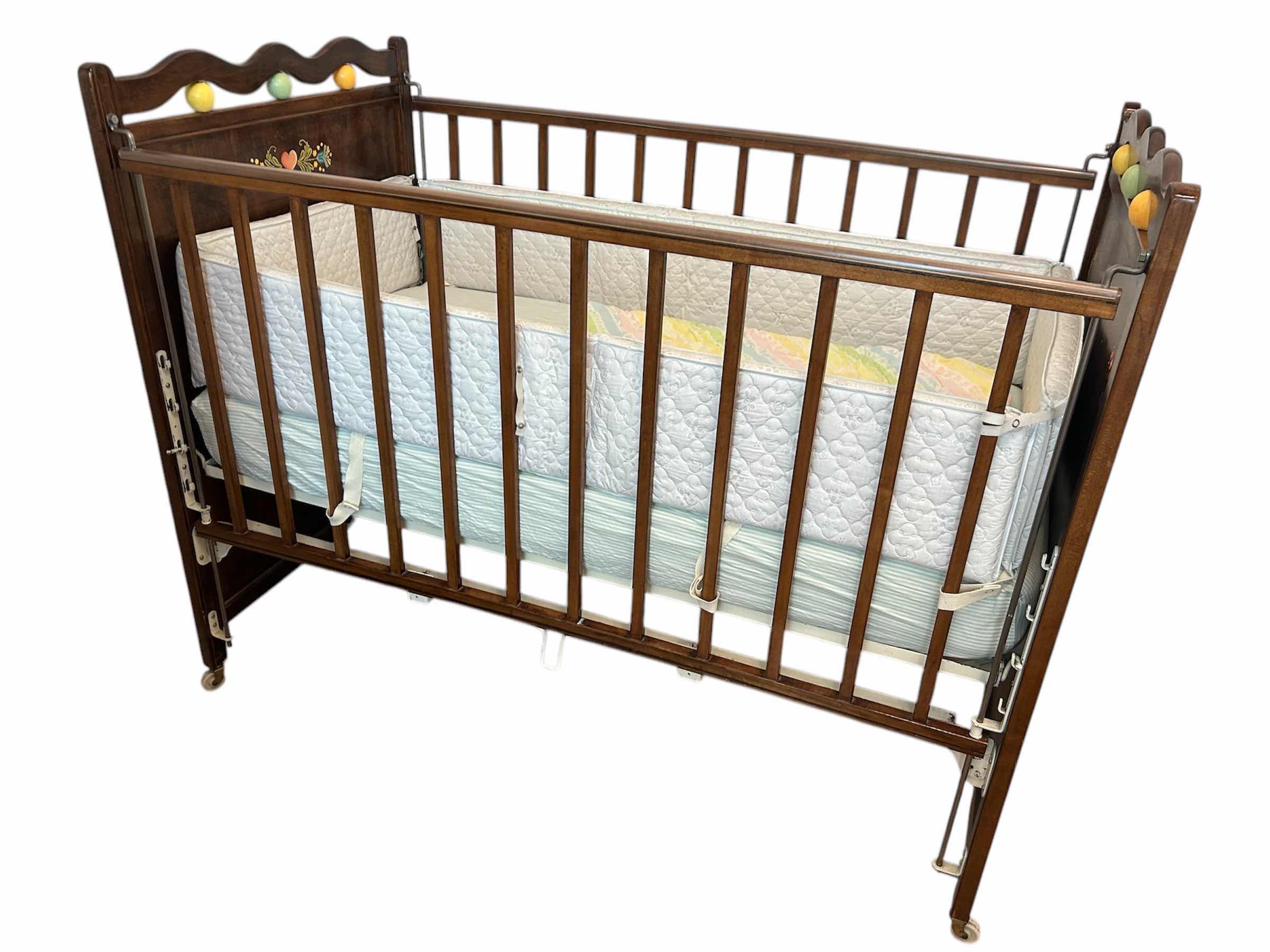 Photo 1 of VINTAGE WOODEN BABY CRIB MID 20th CENTURY FEATURING A DROP SIDE MECHANISM 54” X 30” H 44”