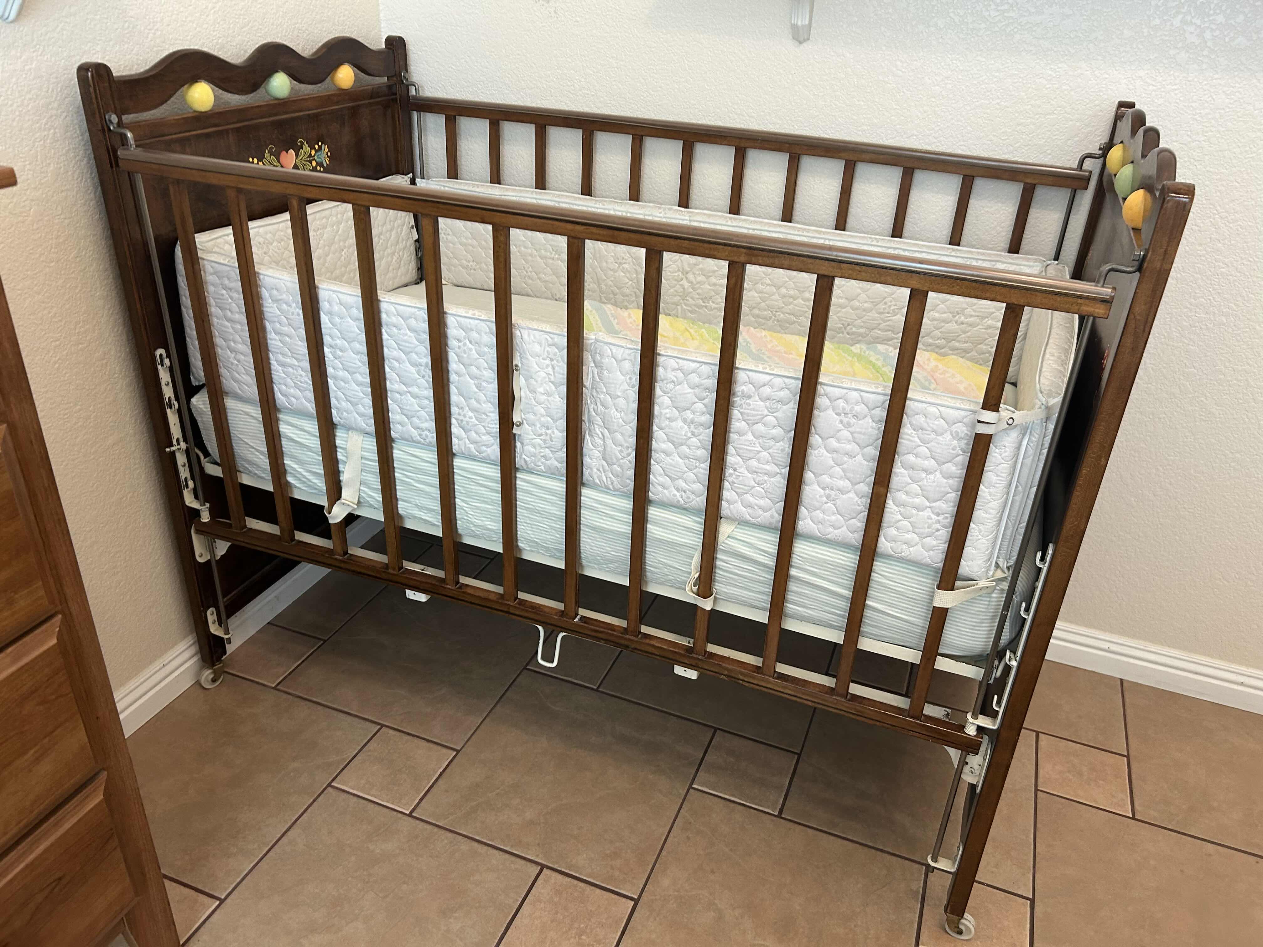 Photo 1 of VINTAGE WOODEN BABY CRIB MID 20th CENTURY FEATURING A DROP SIDE MECHANISM 54” X 30” H 44”