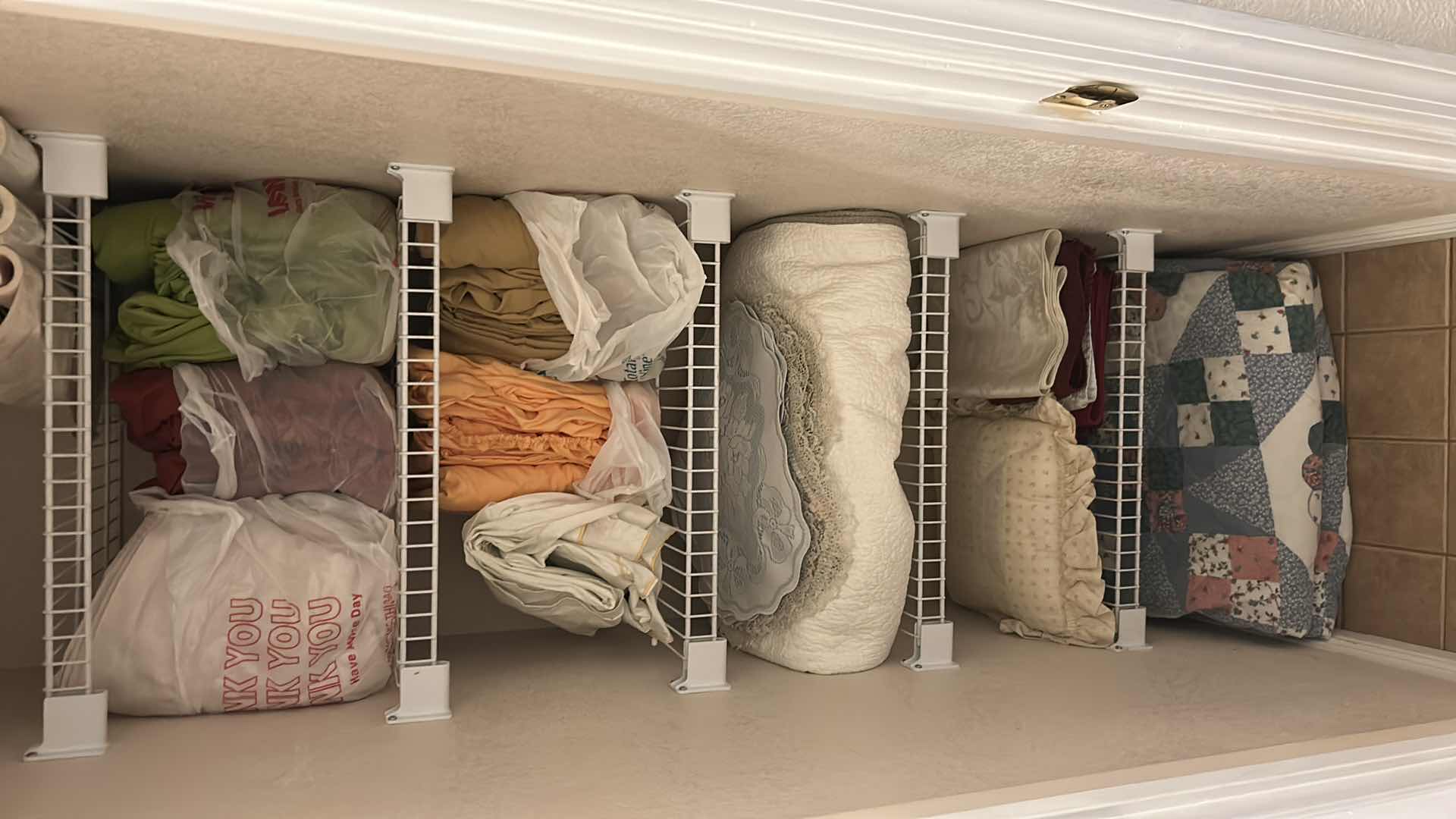 Photo 1 of CONTENTS OF CLOSET ASSORTED SHEETS QUILTS PLACEMATS