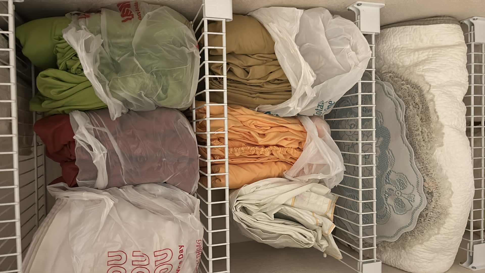 Photo 2 of CONTENTS OF CLOSET ASSORTED SHEETS QUILTS PLACEMATS