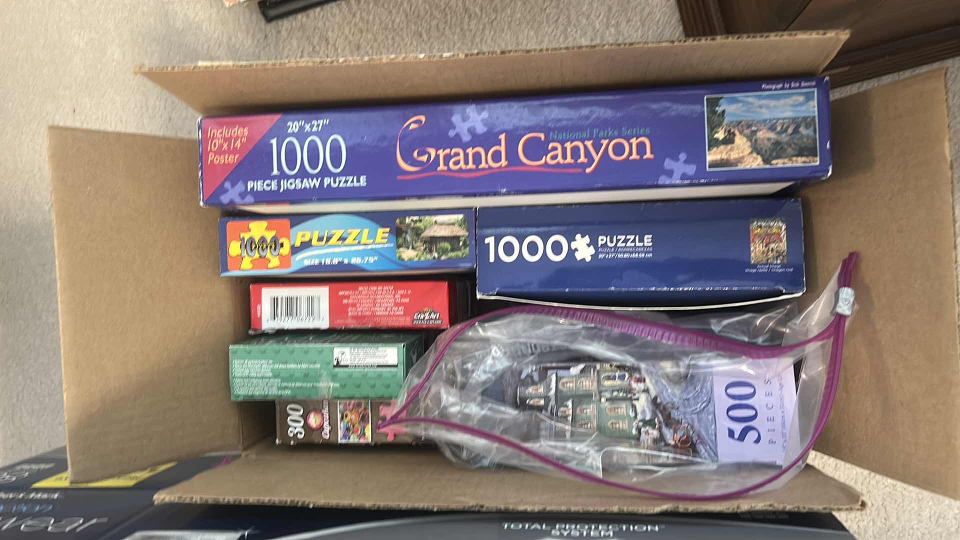 Photo 1 of 2 BOXES OF PUZZLES