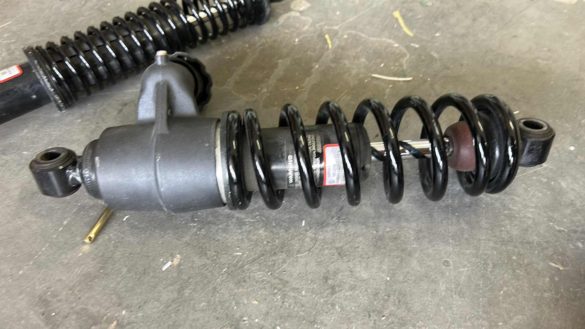 Photo 1 of 2 MOTORCYCLE REAR SHOCKS LIKELY HARLEY DAVIDSON GIVEN THE TEXT,  "GPRELO OSPRING STMENT"