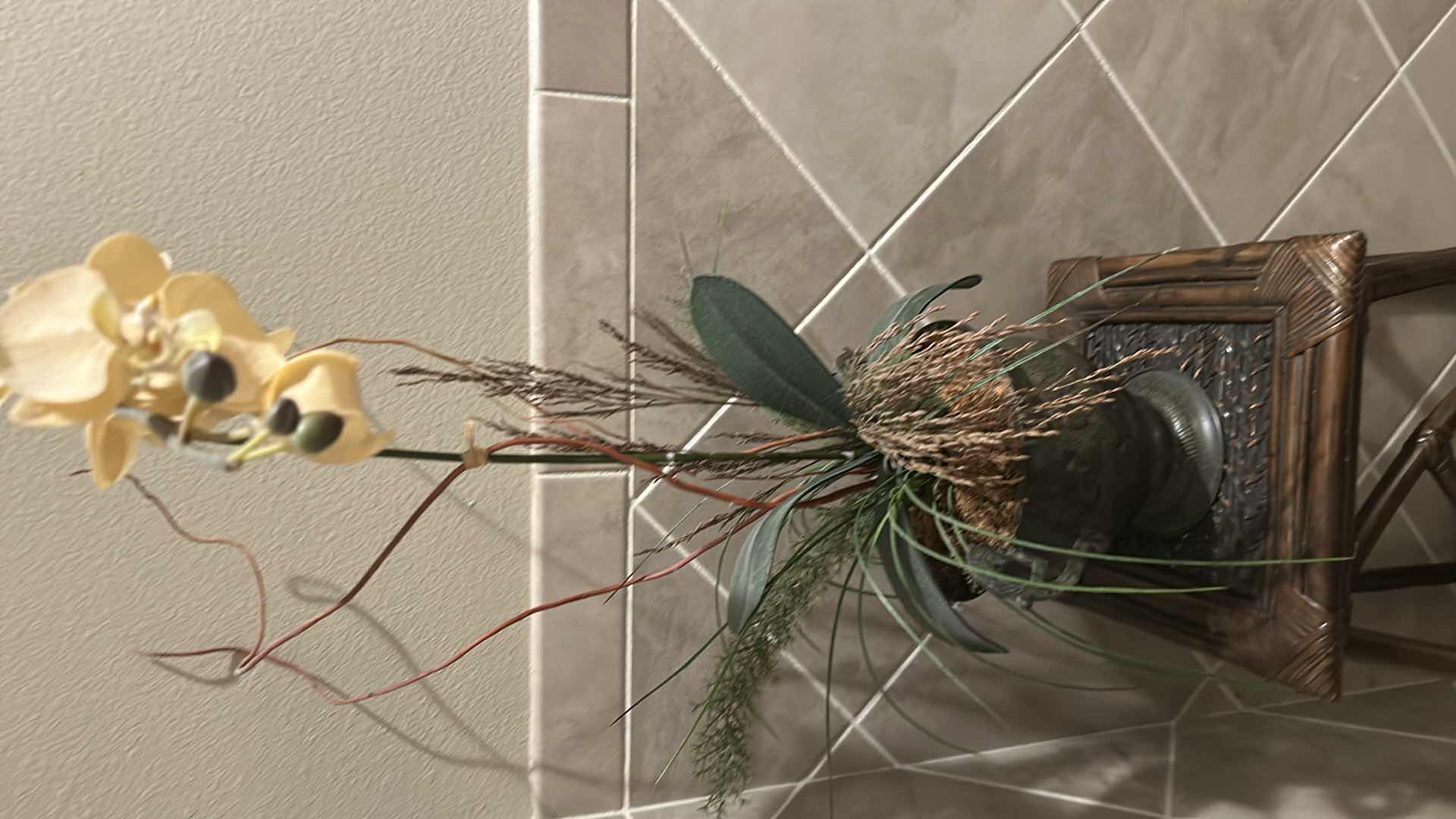 Photo 1 of FAUX ORCHID PLANT IN METAL POT W RATTAN LOWER SHELF AND X SHAPED  BASE H 51"